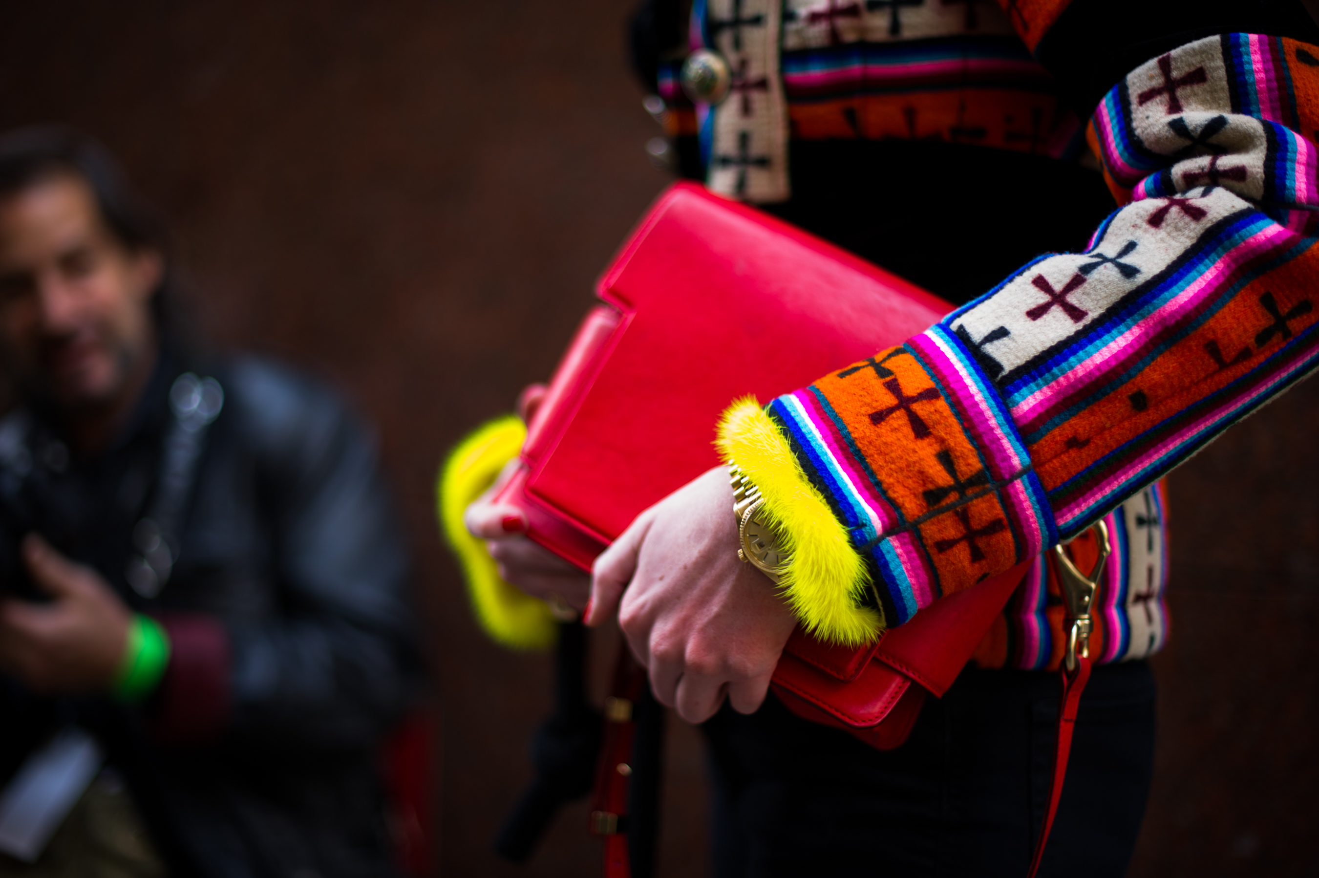 Woman holding red clutch bag