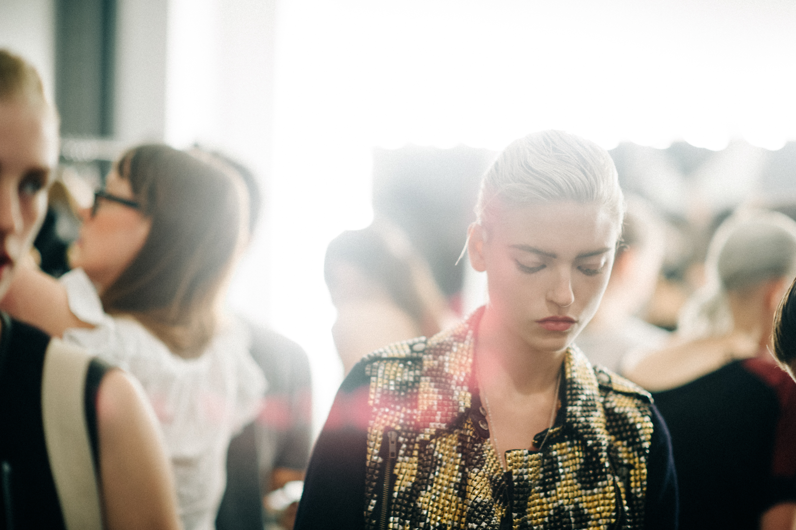 Model wearing studded jacket before show
