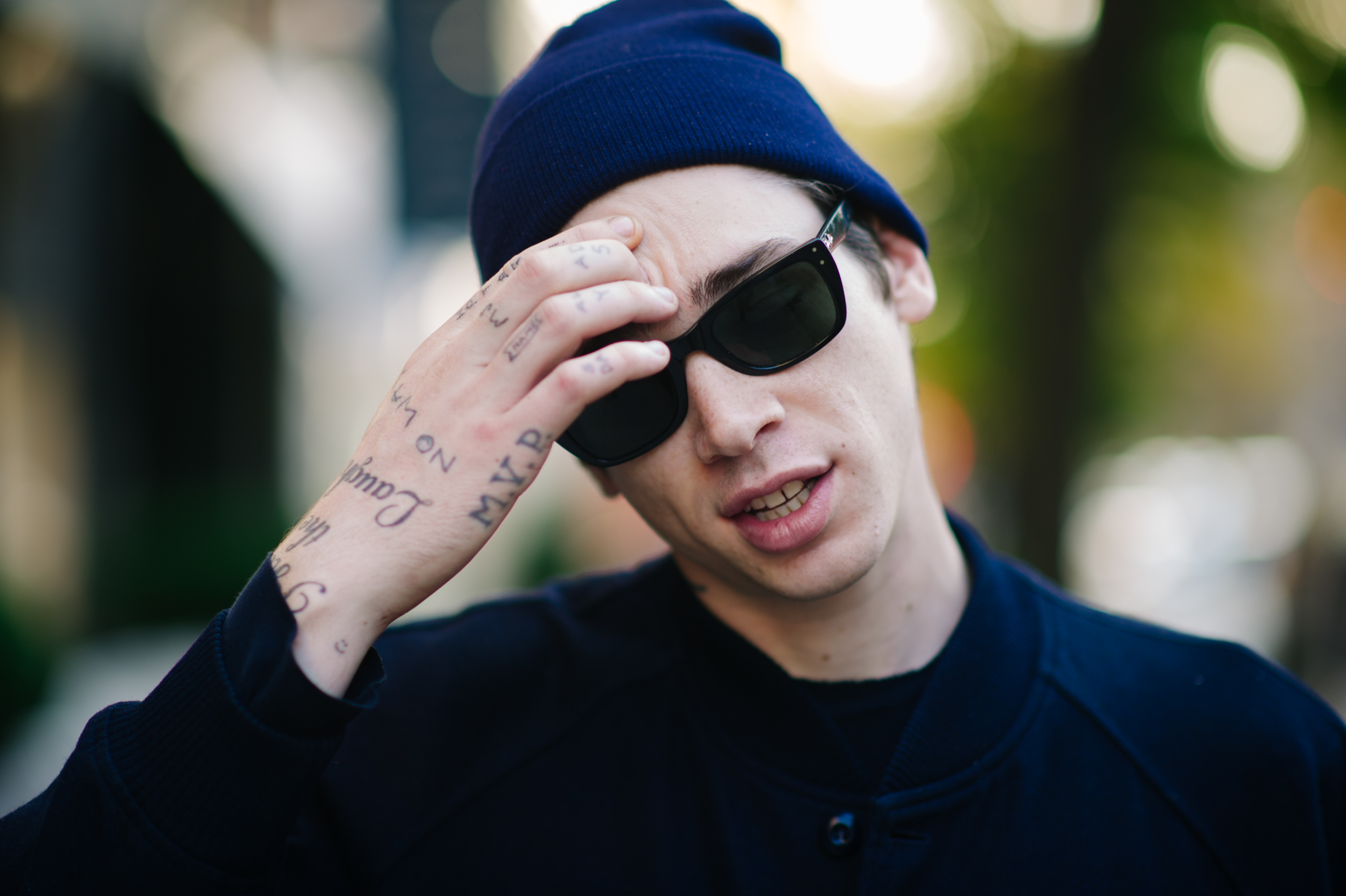 Man with tatttooes wears blue hat