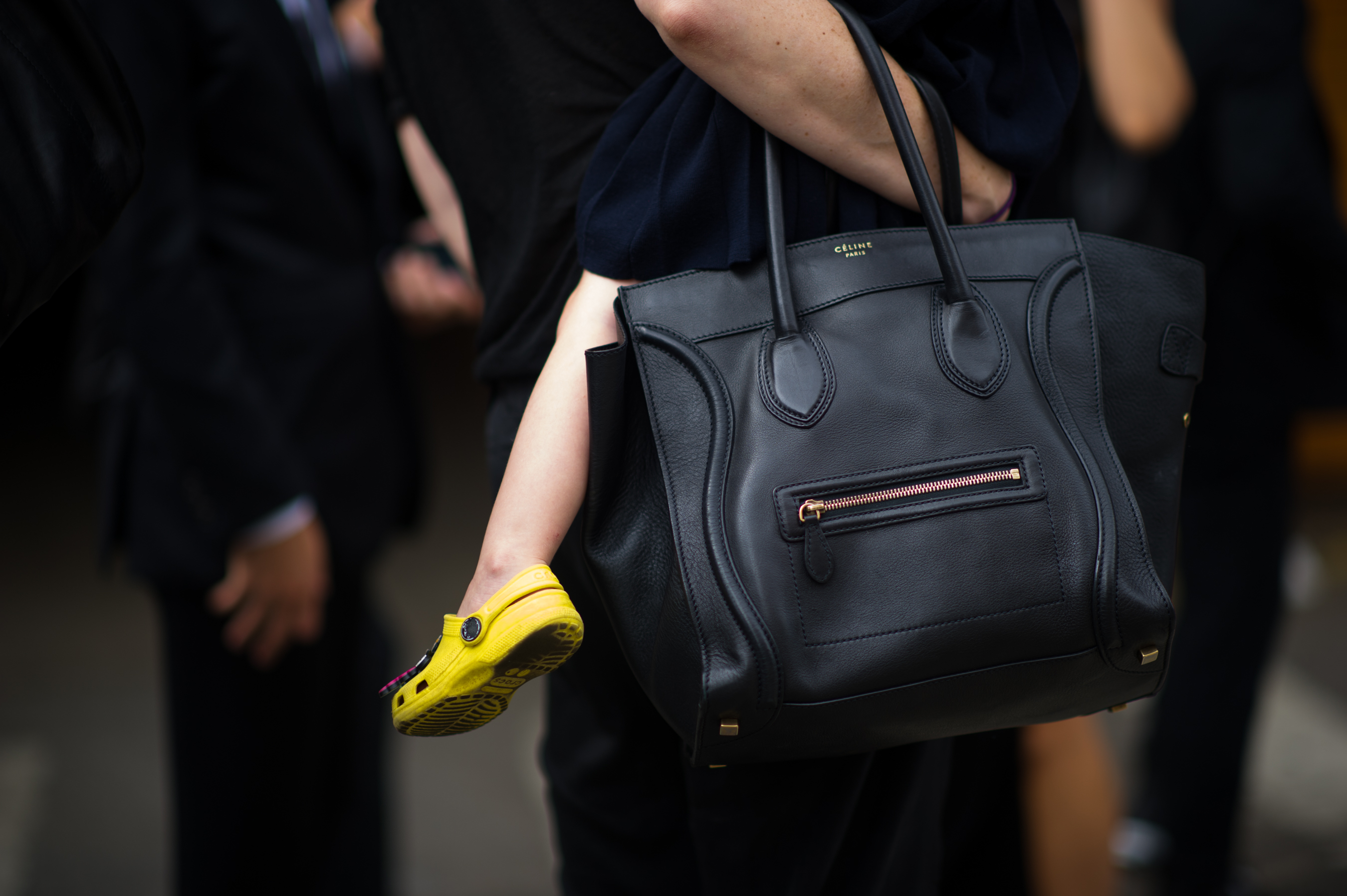 Woman holding baby and Celine bag