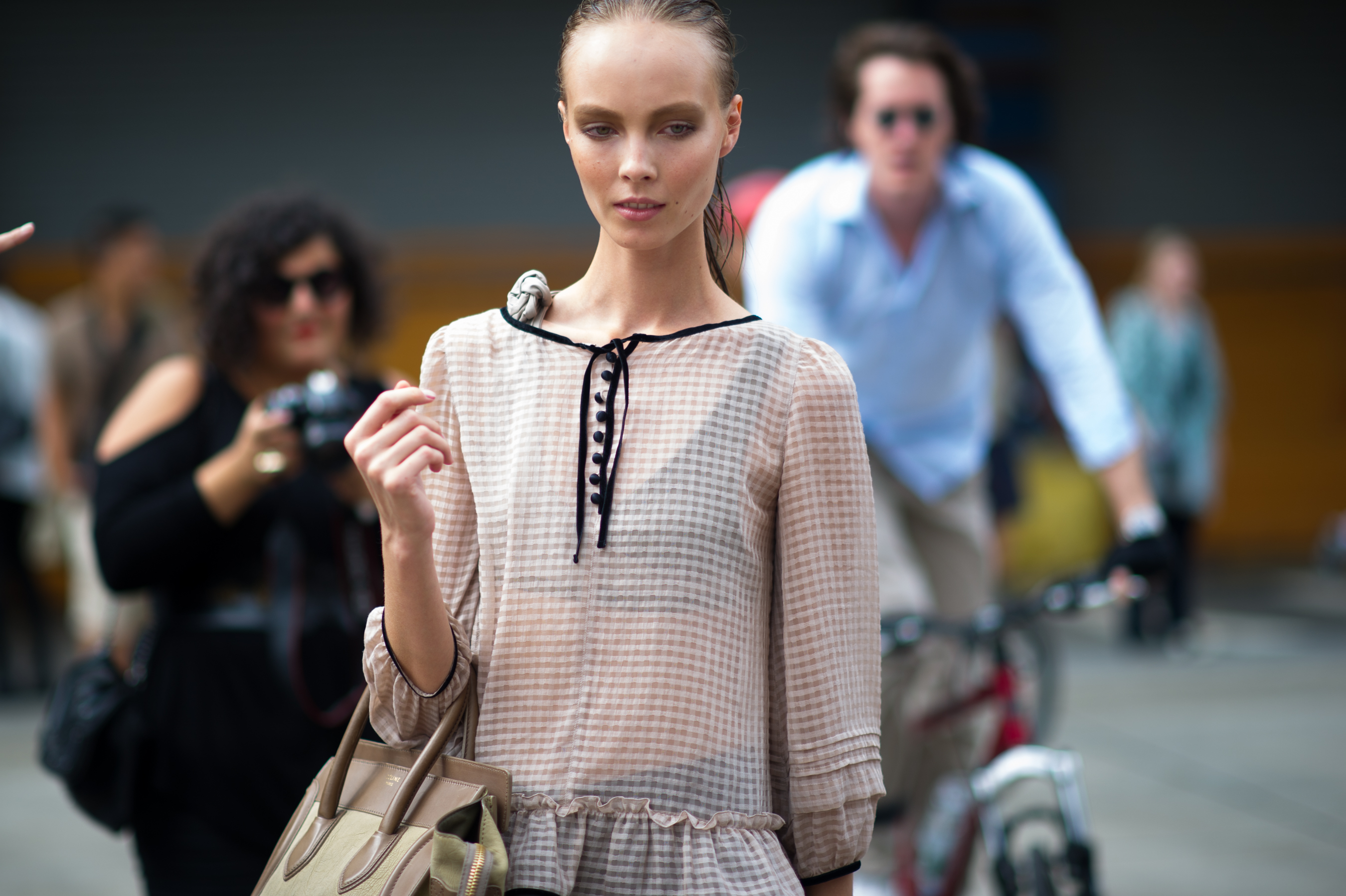 Model wearing beige transparent top