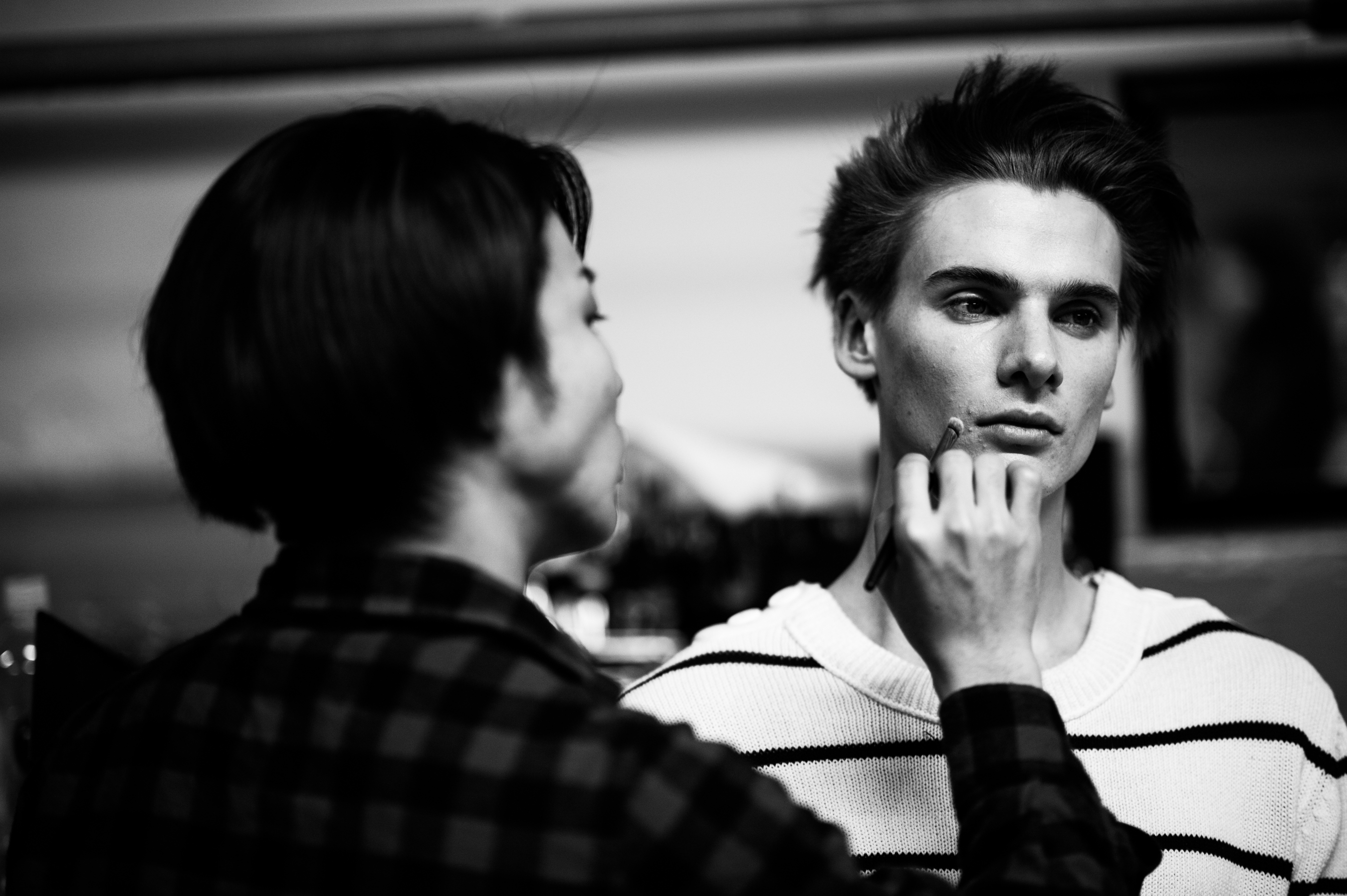 Male model getting make up done