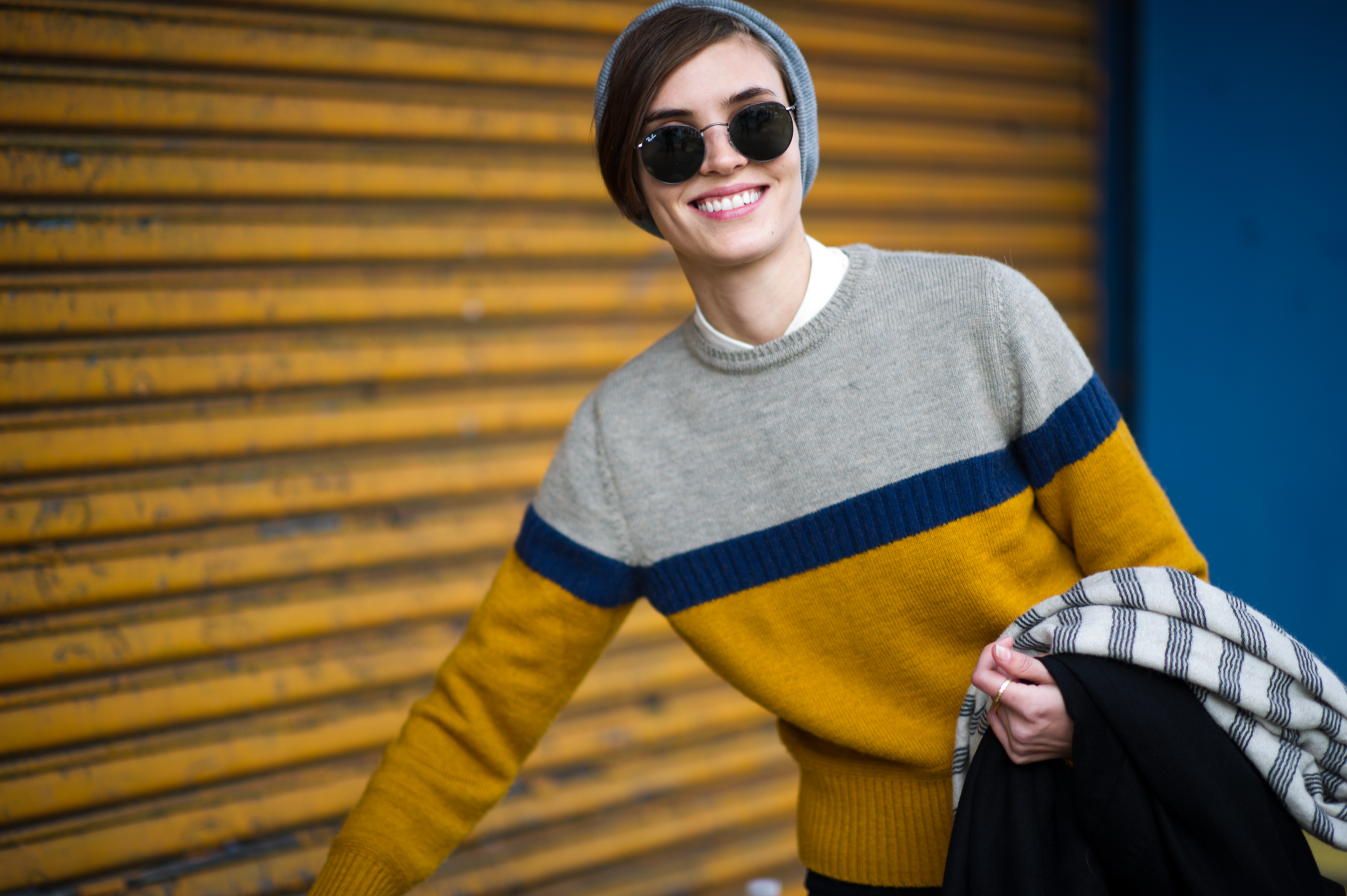 Girl wearing yellow sweater and hat