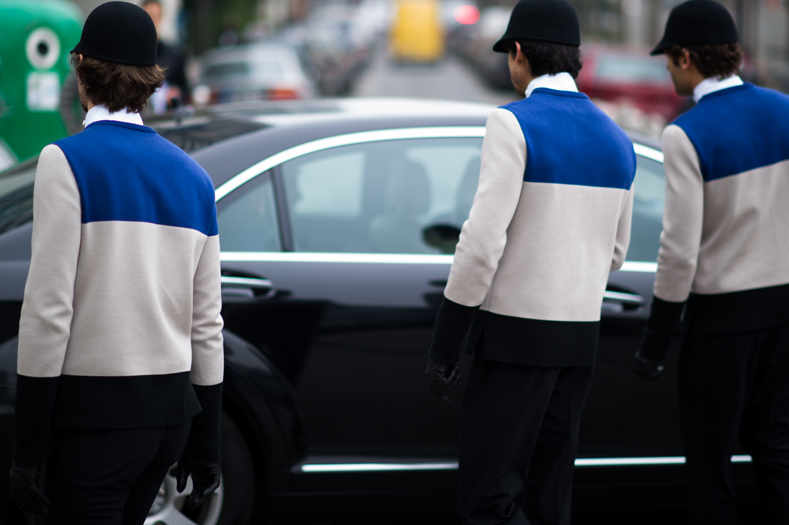 Three men wearing identical jackets
