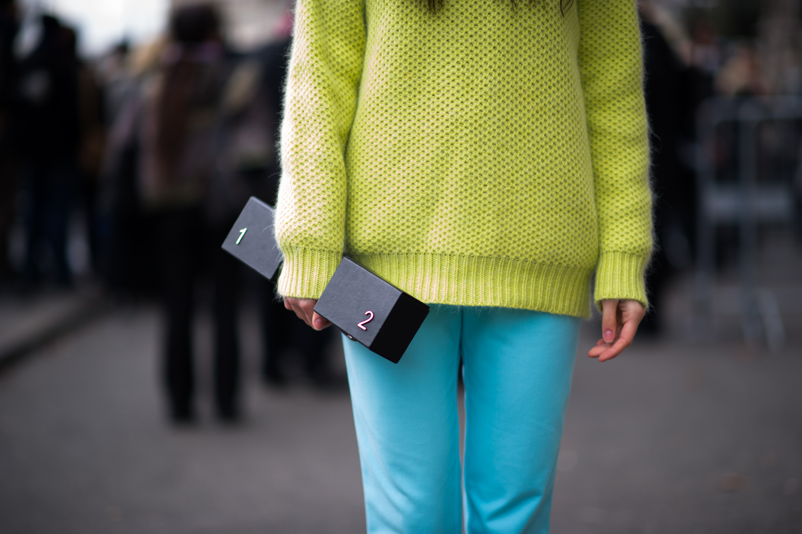 Woman holding weight shaped clutch