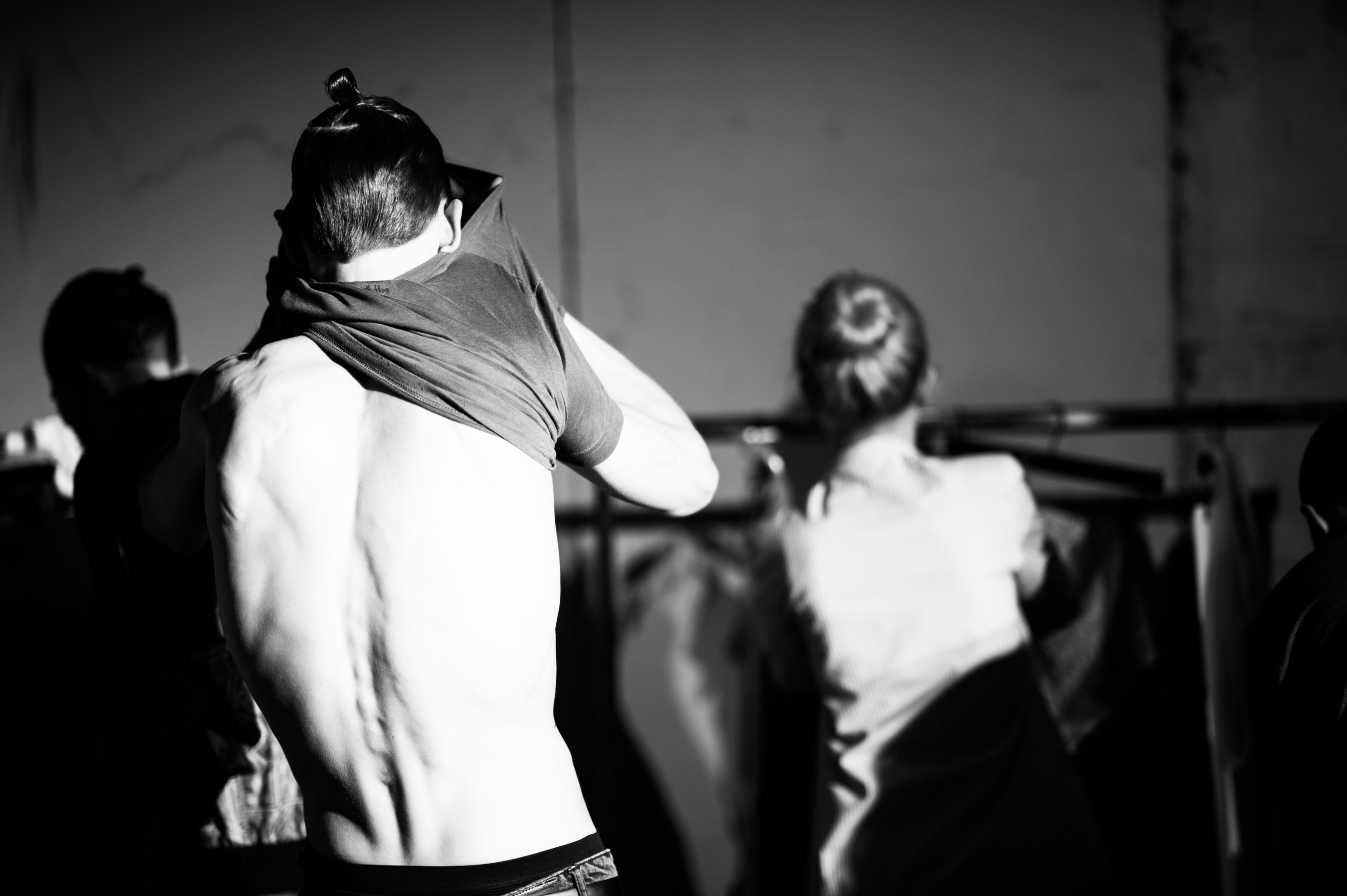 Male-Model-Putting-On-Shirt