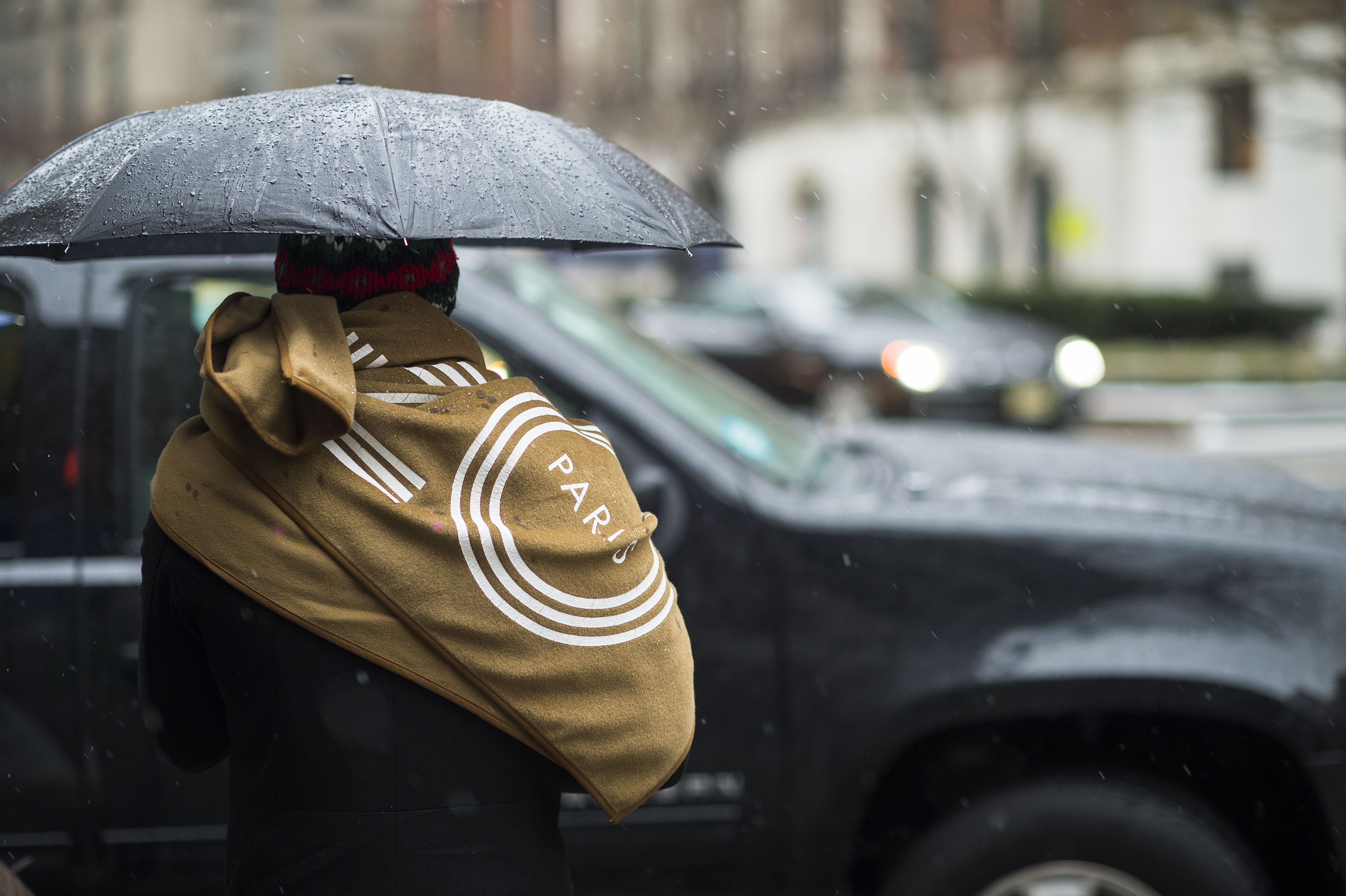 Man with umbrella wearing scarf