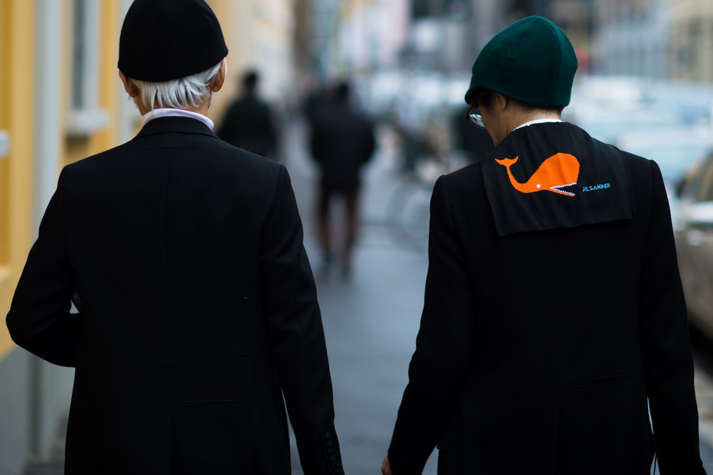 Two men wearing black hats
