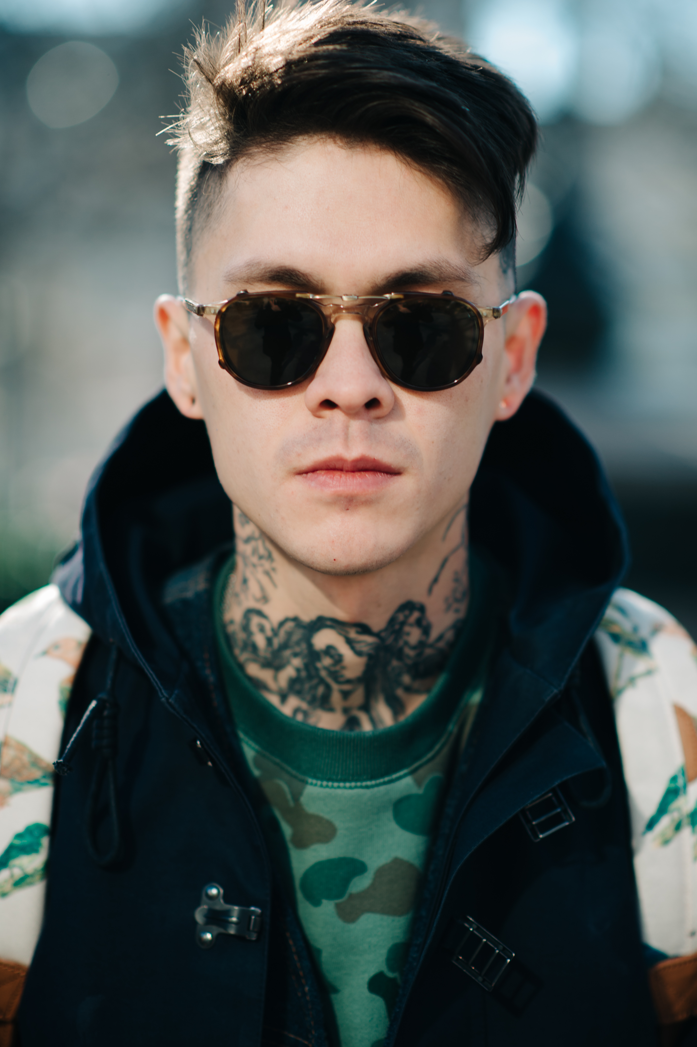 Portrait of a tattooed man wearing glasses