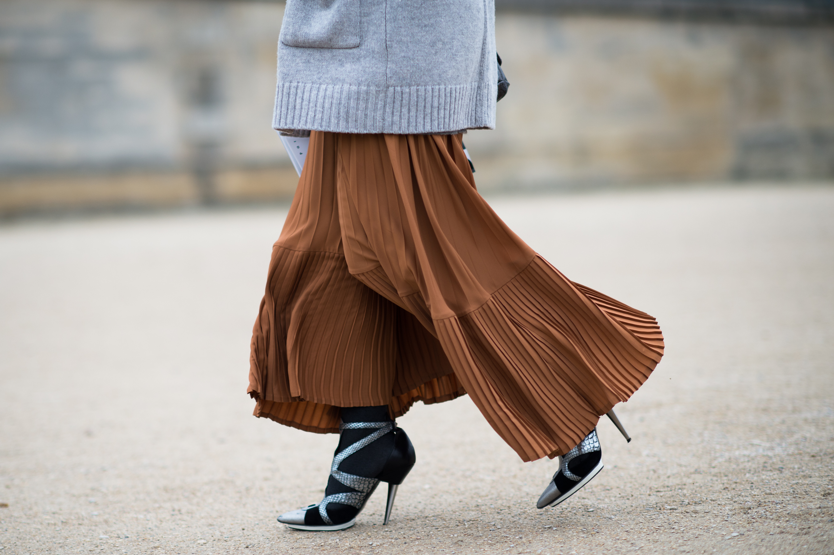 Woman wearing orange skirt and heels