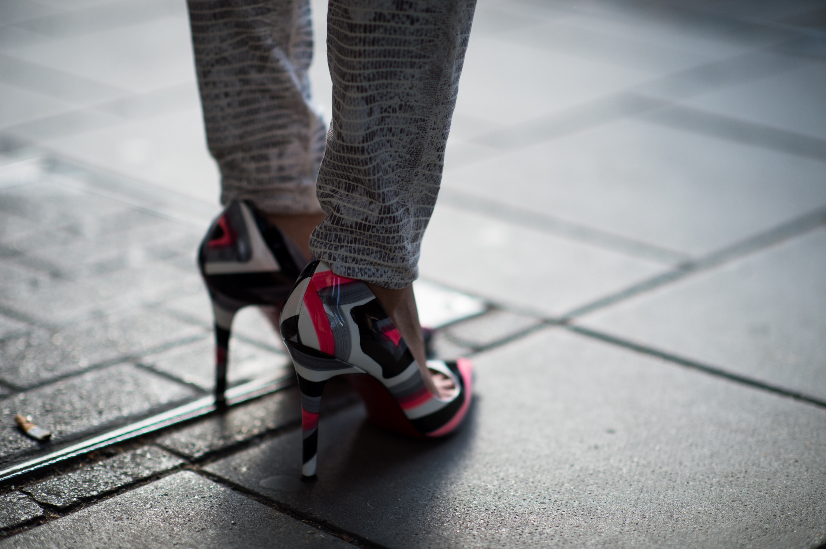 Woman wearing painted Louboutin heels
