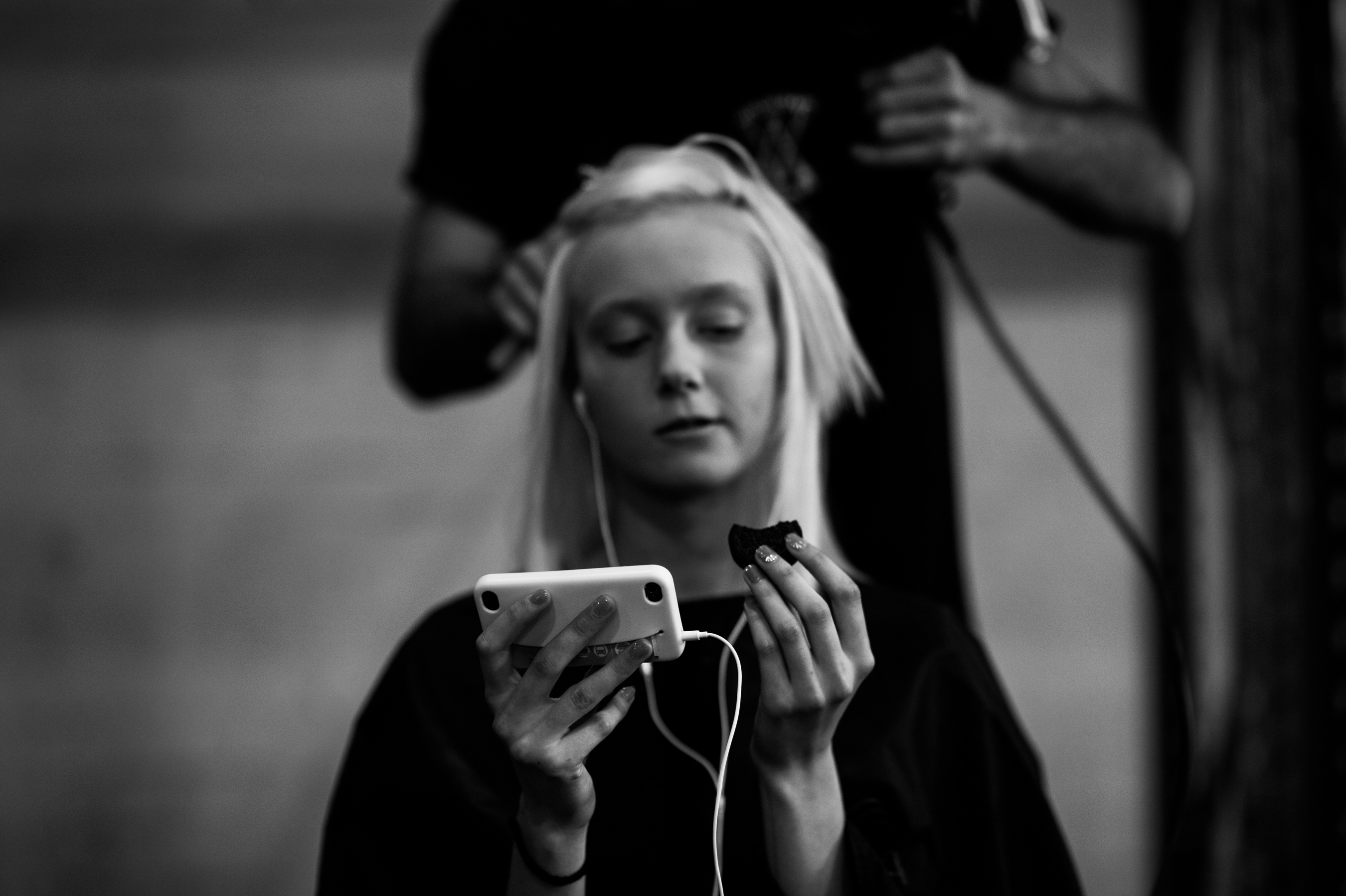 Blonde model eating cookie before show