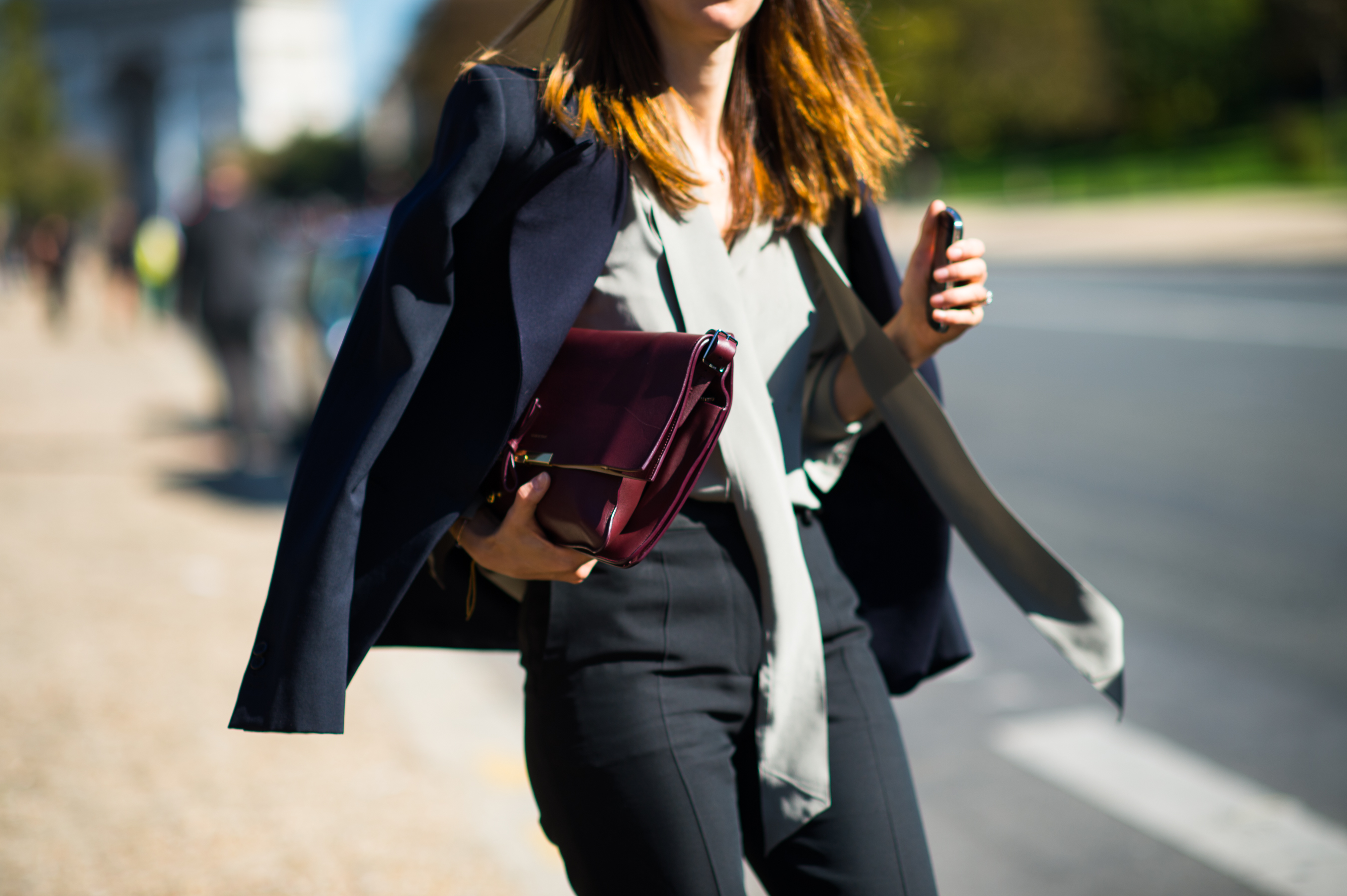 Woman oxblood Céline clutch navy blazer