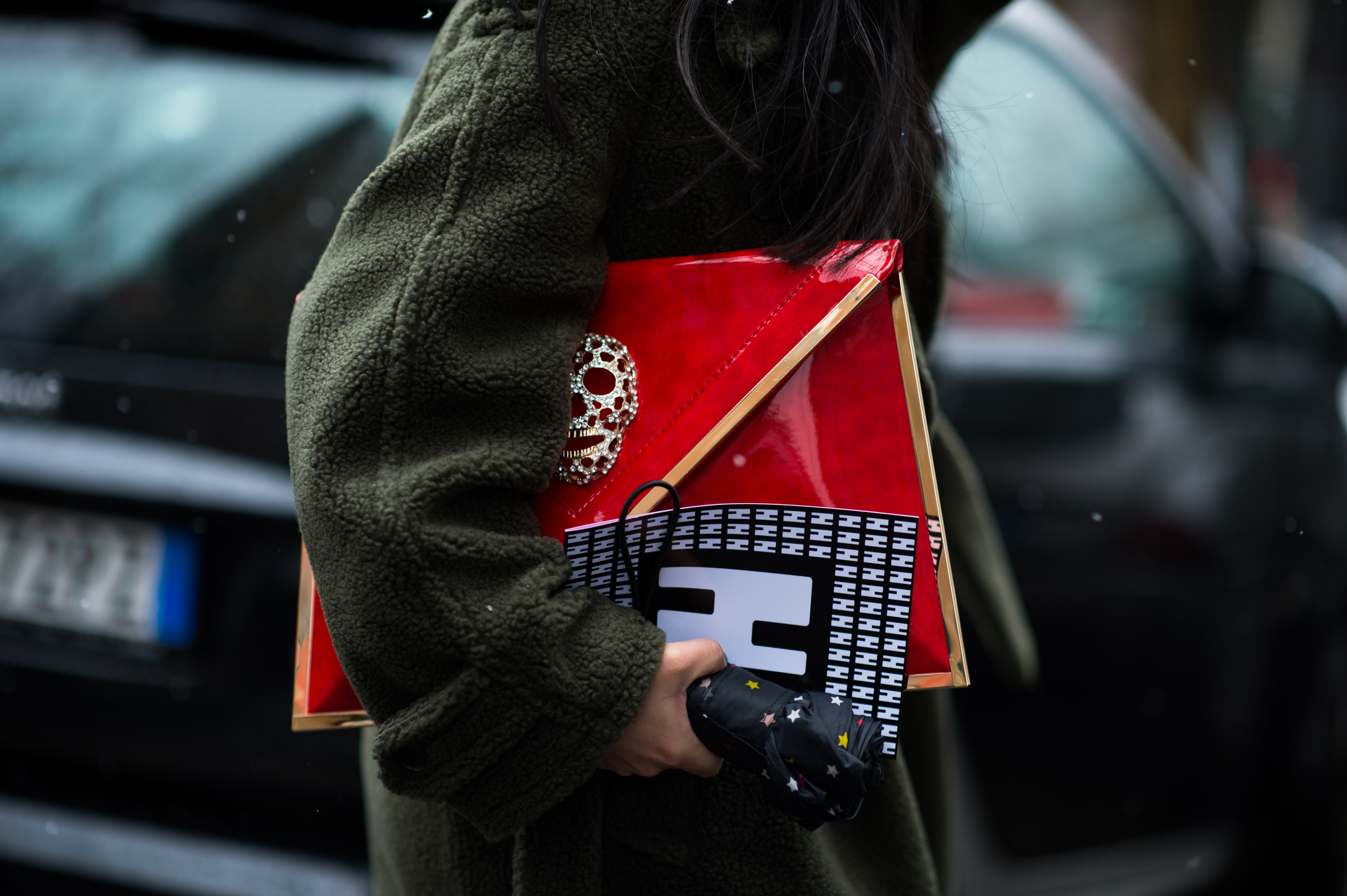 Woman carrying skull diamond clutch
