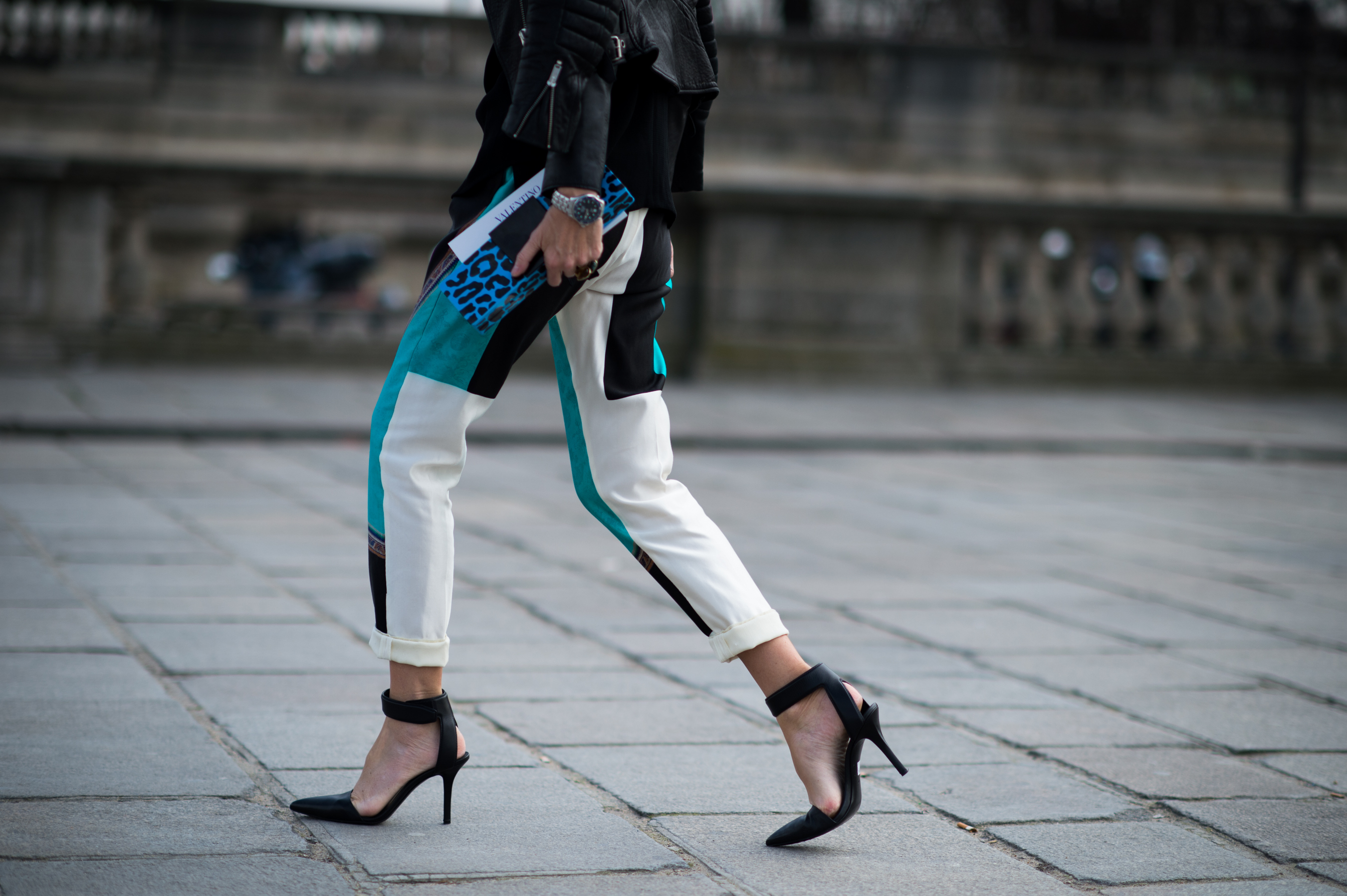 Woman walking print pants heels