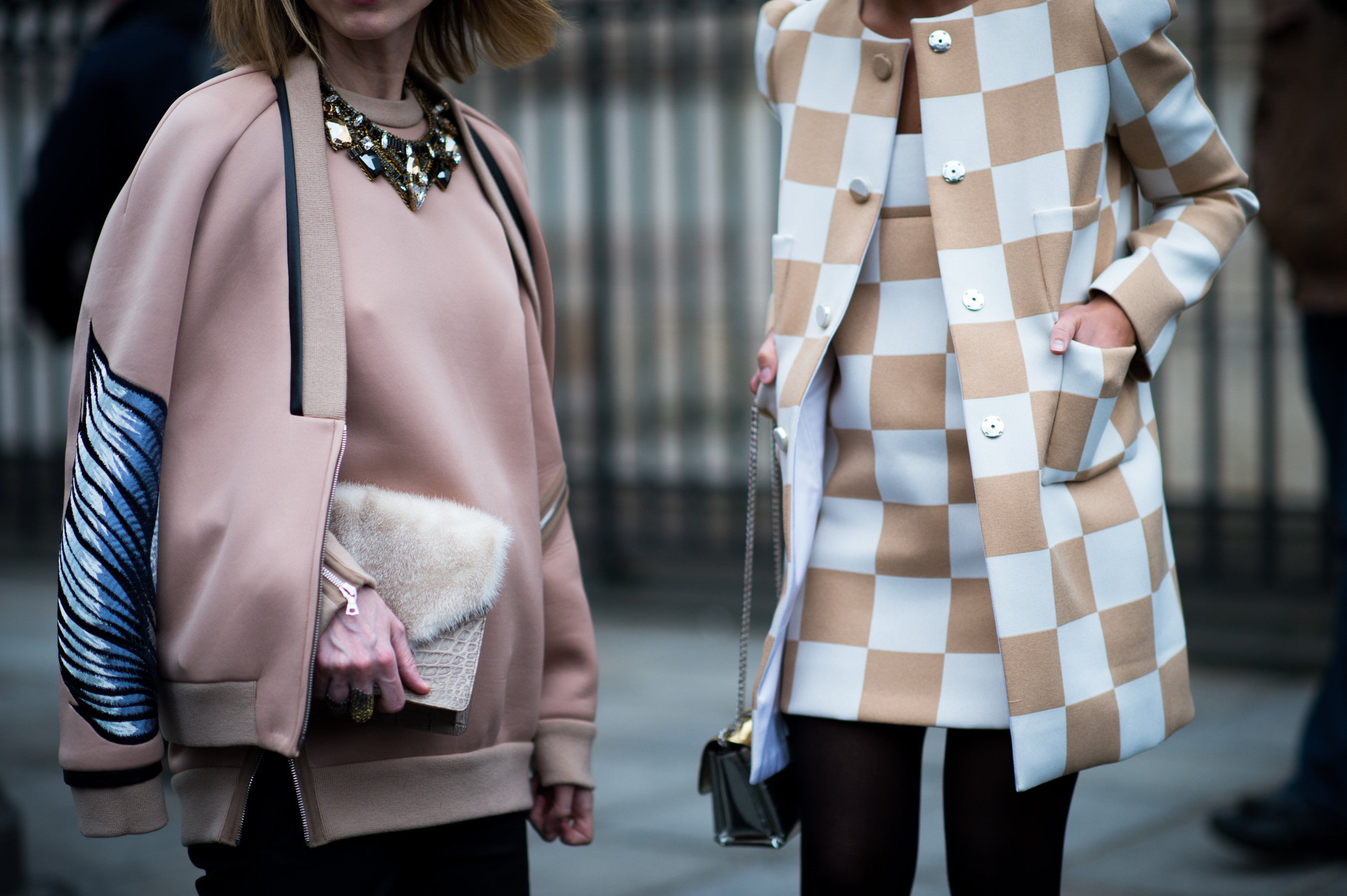 Two women wearing nude colour outfits