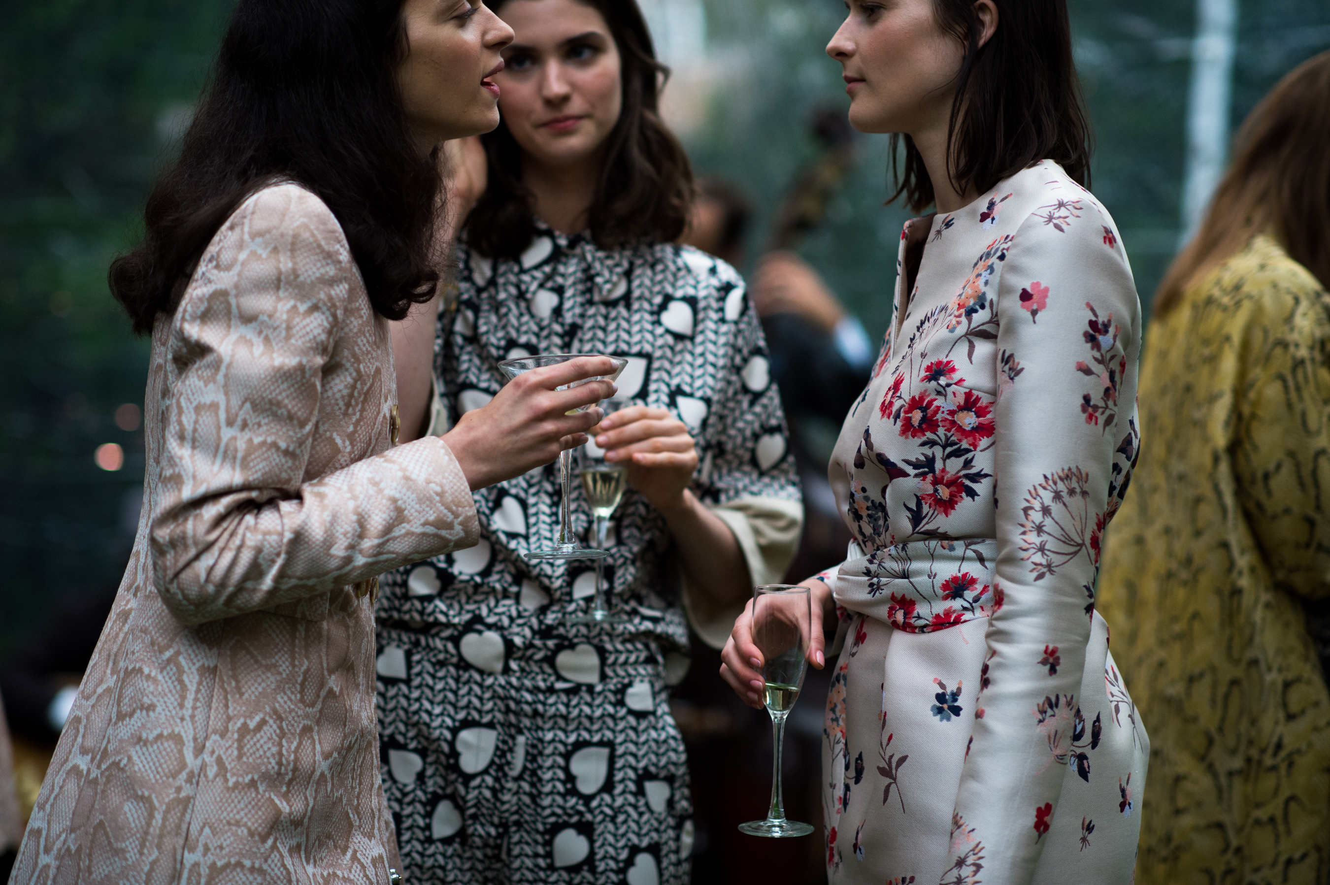 Three models drinking at fashion show