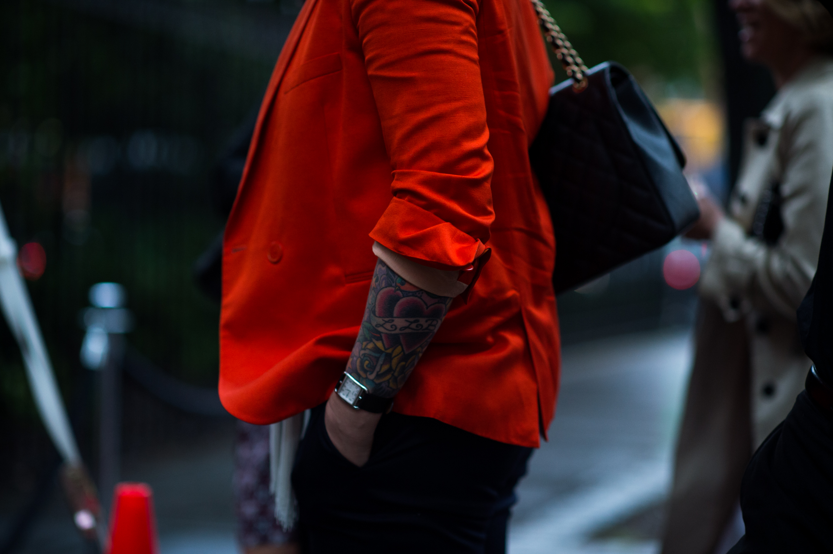 Woman with tattoos and red jacket