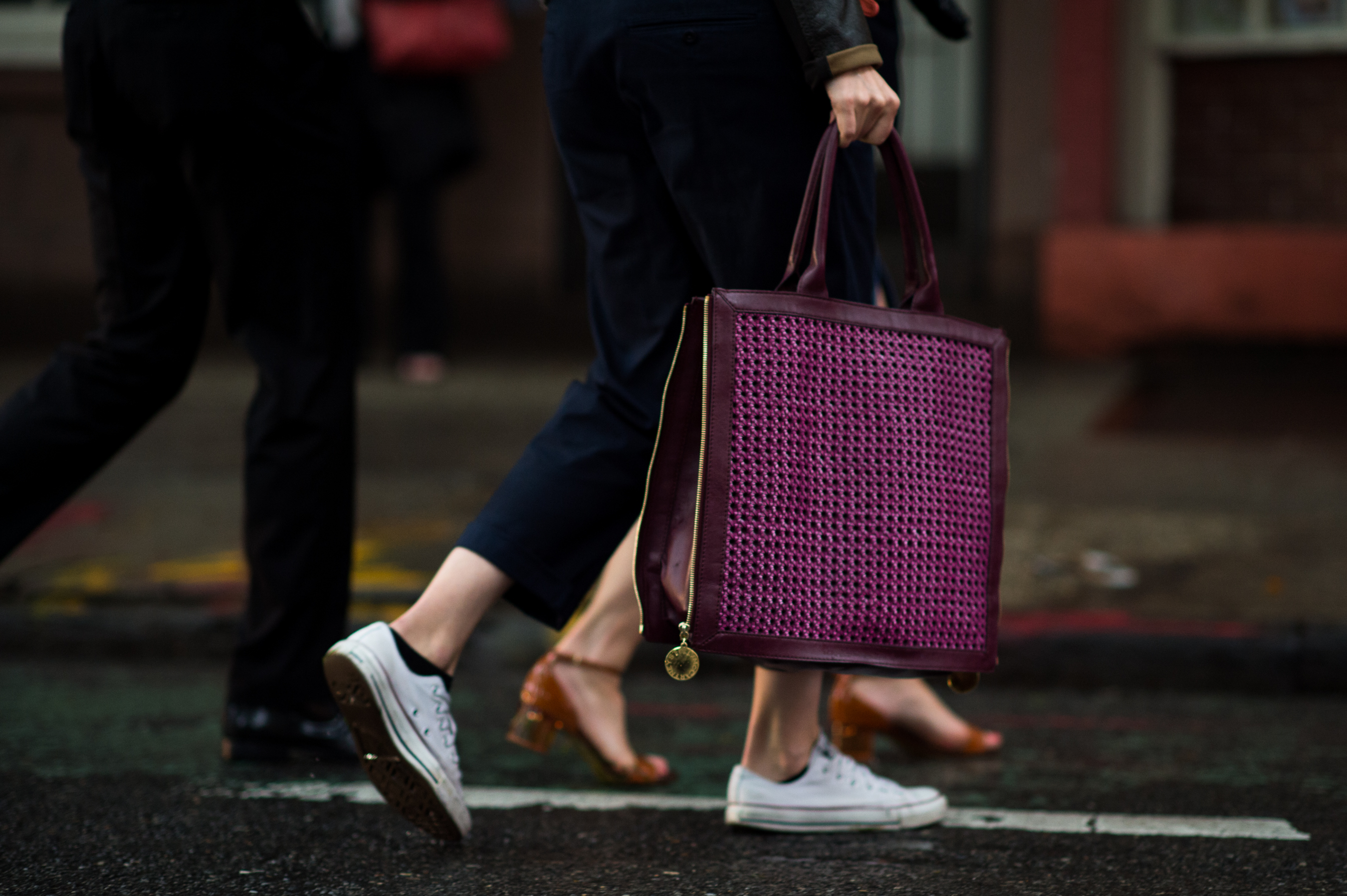 Girl carrying purple woven bag in rain
