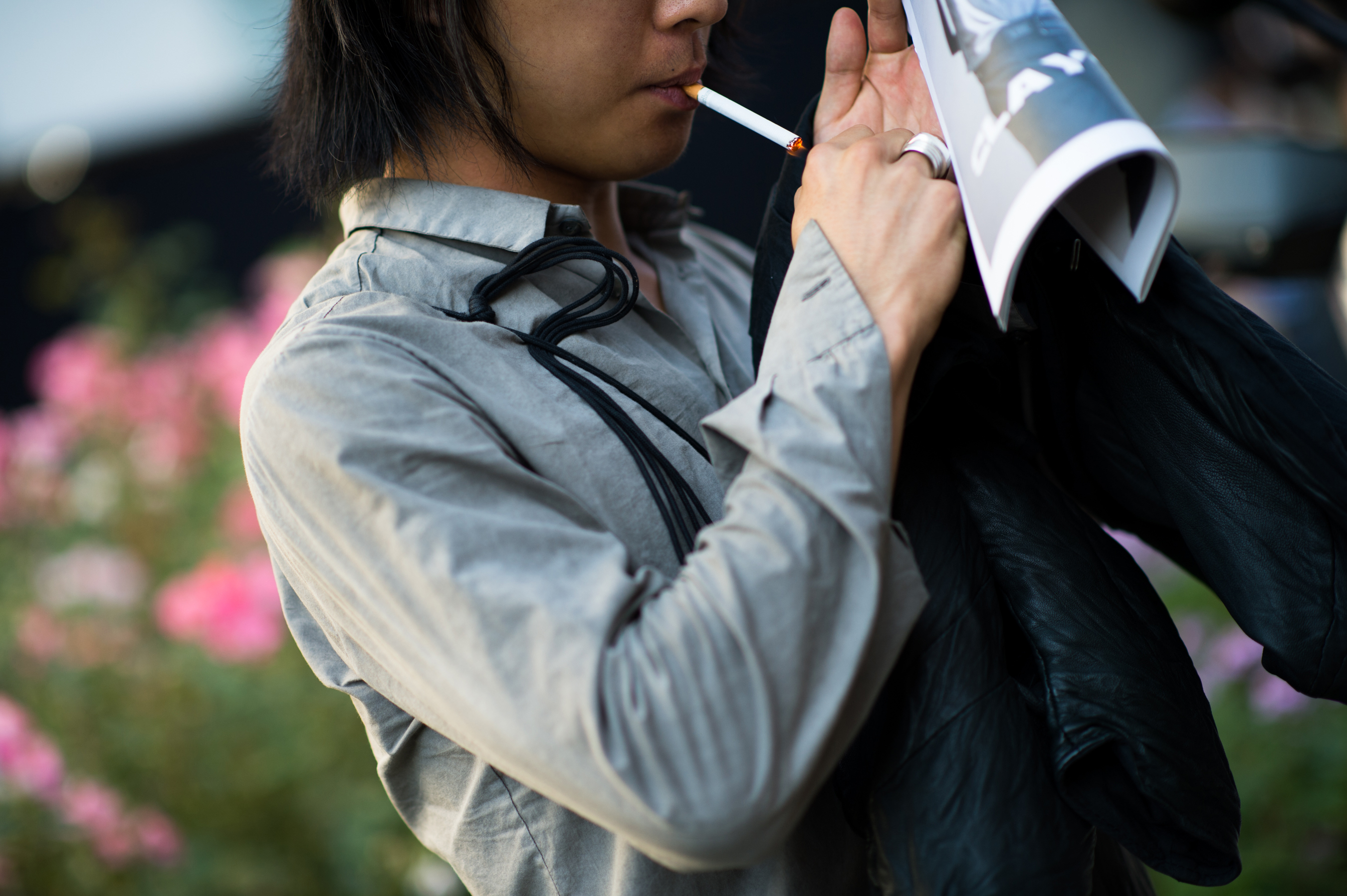 Korean man smoking cigarette in Milano