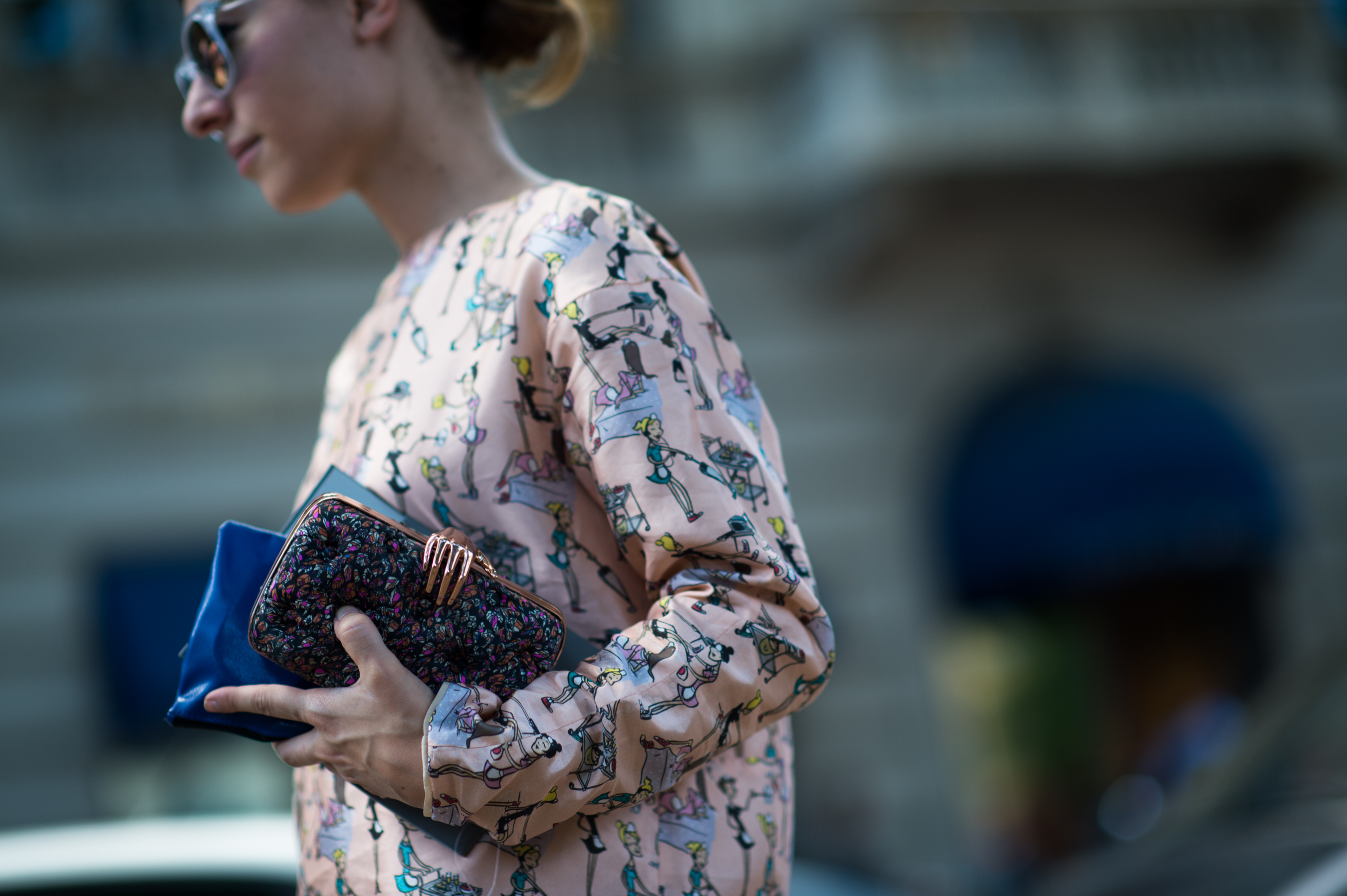 Woman holding clutch with metal hand