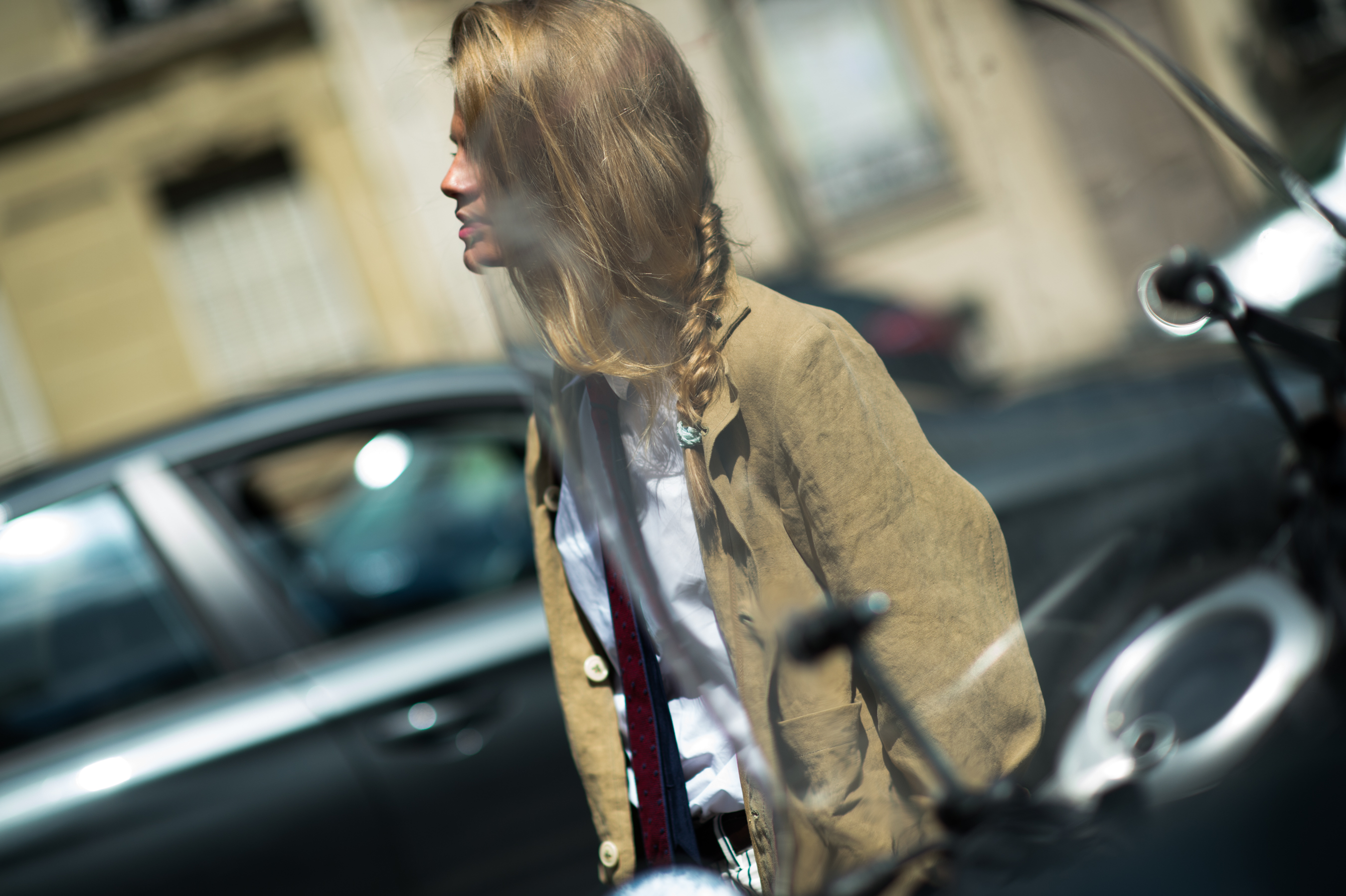 Girl wearing menswear in front of scooter