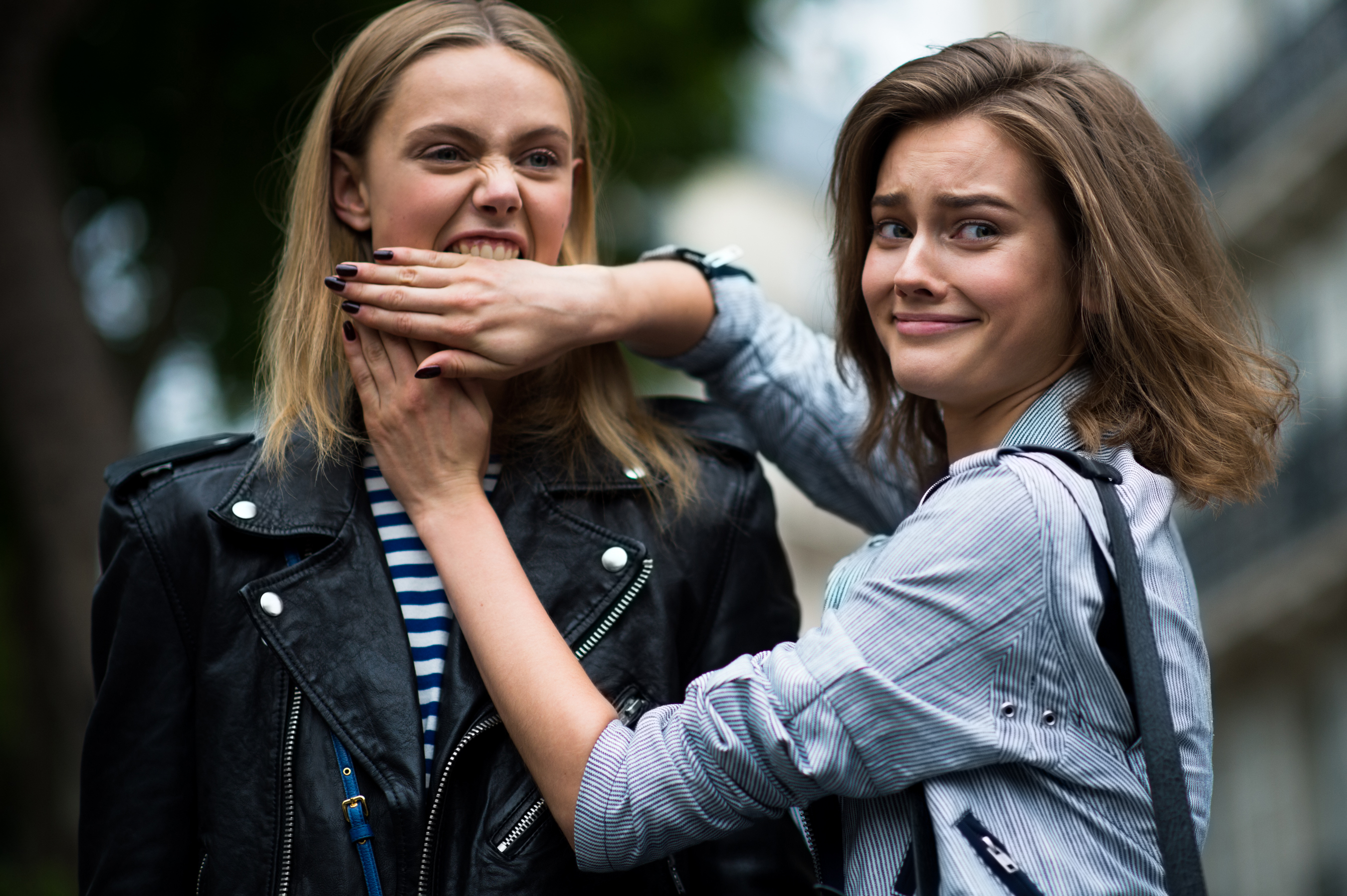 Two models biting hands PFW
