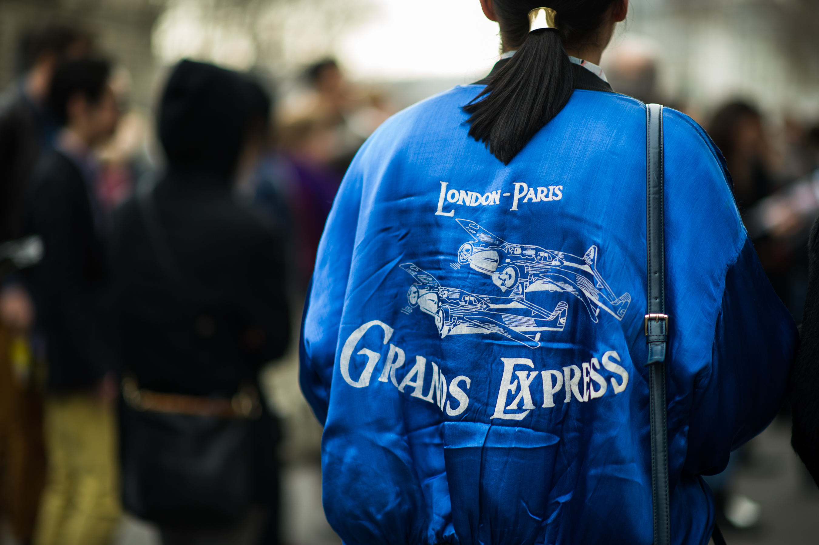 Woman wearing blue embroidered bomber