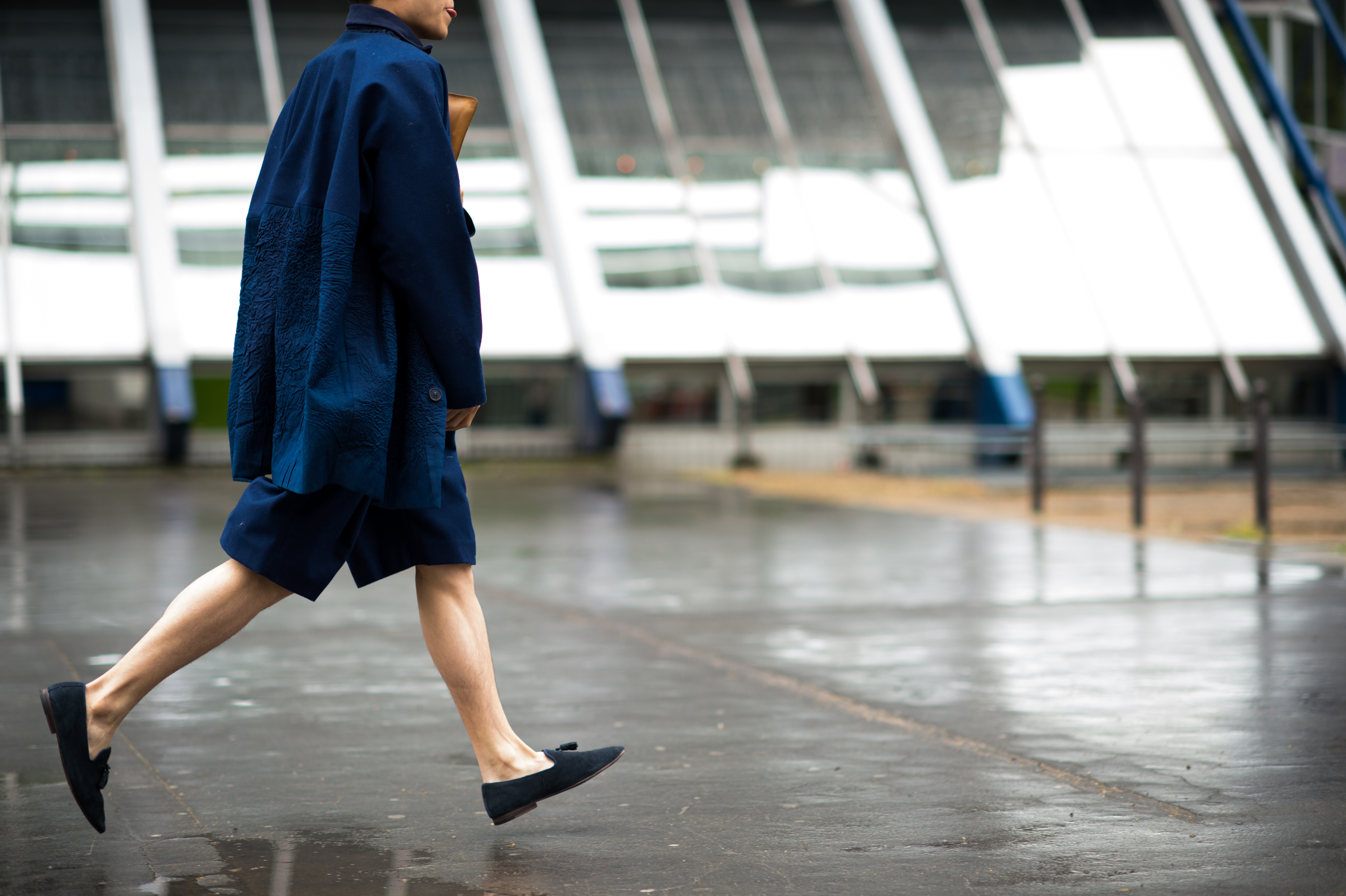 Man running in blue coat to fashion show
