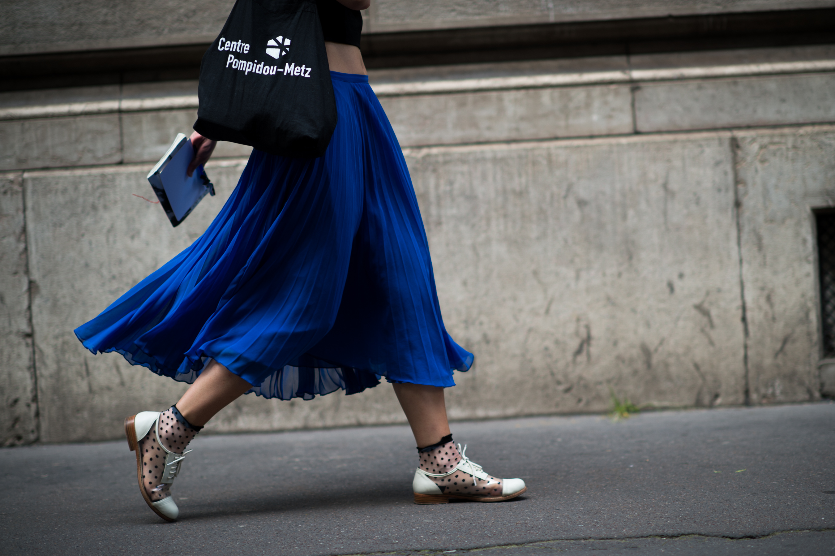 Woman wearing blue pleated skirt