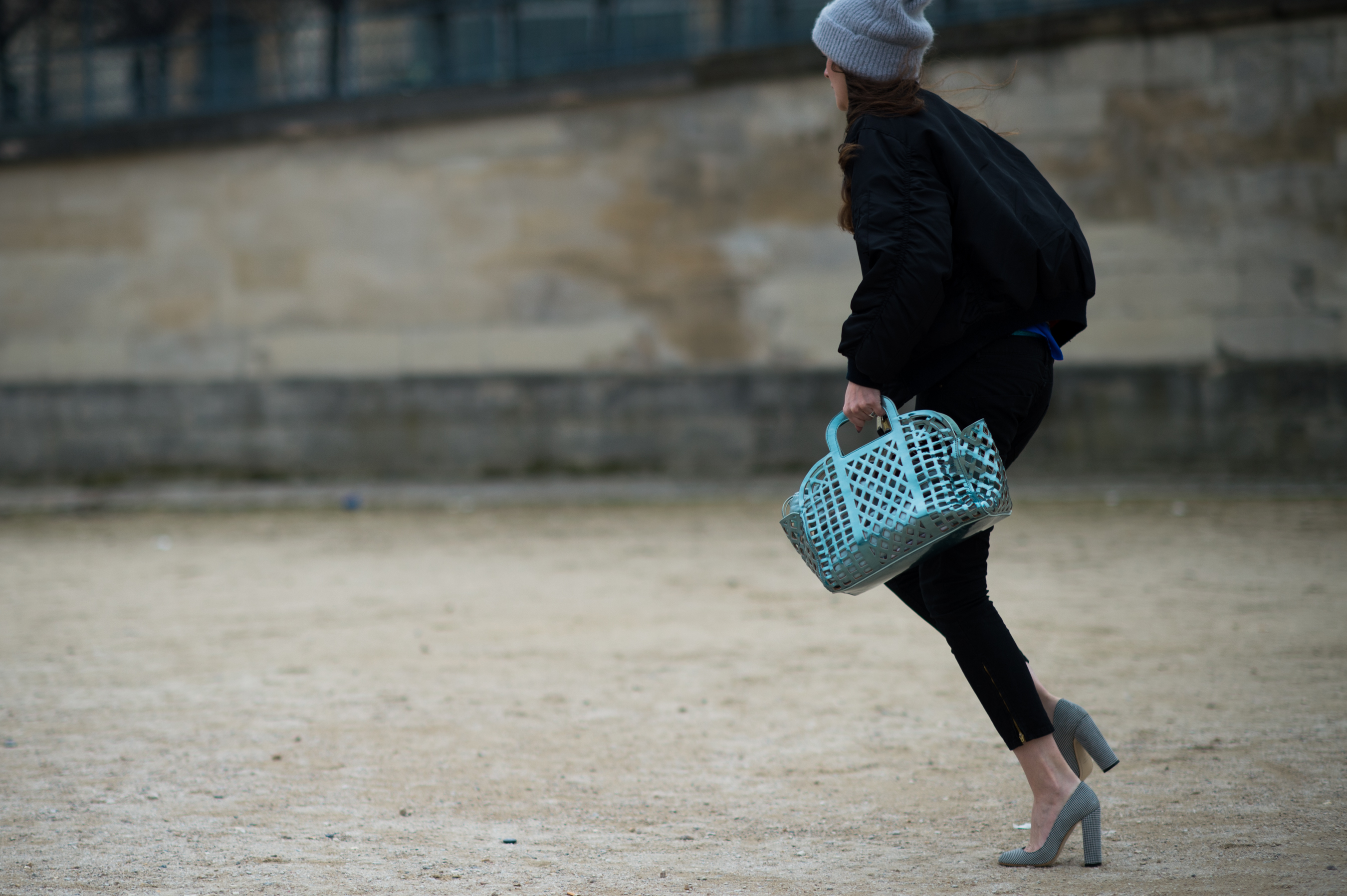 Woman running with plastic turquoise bag