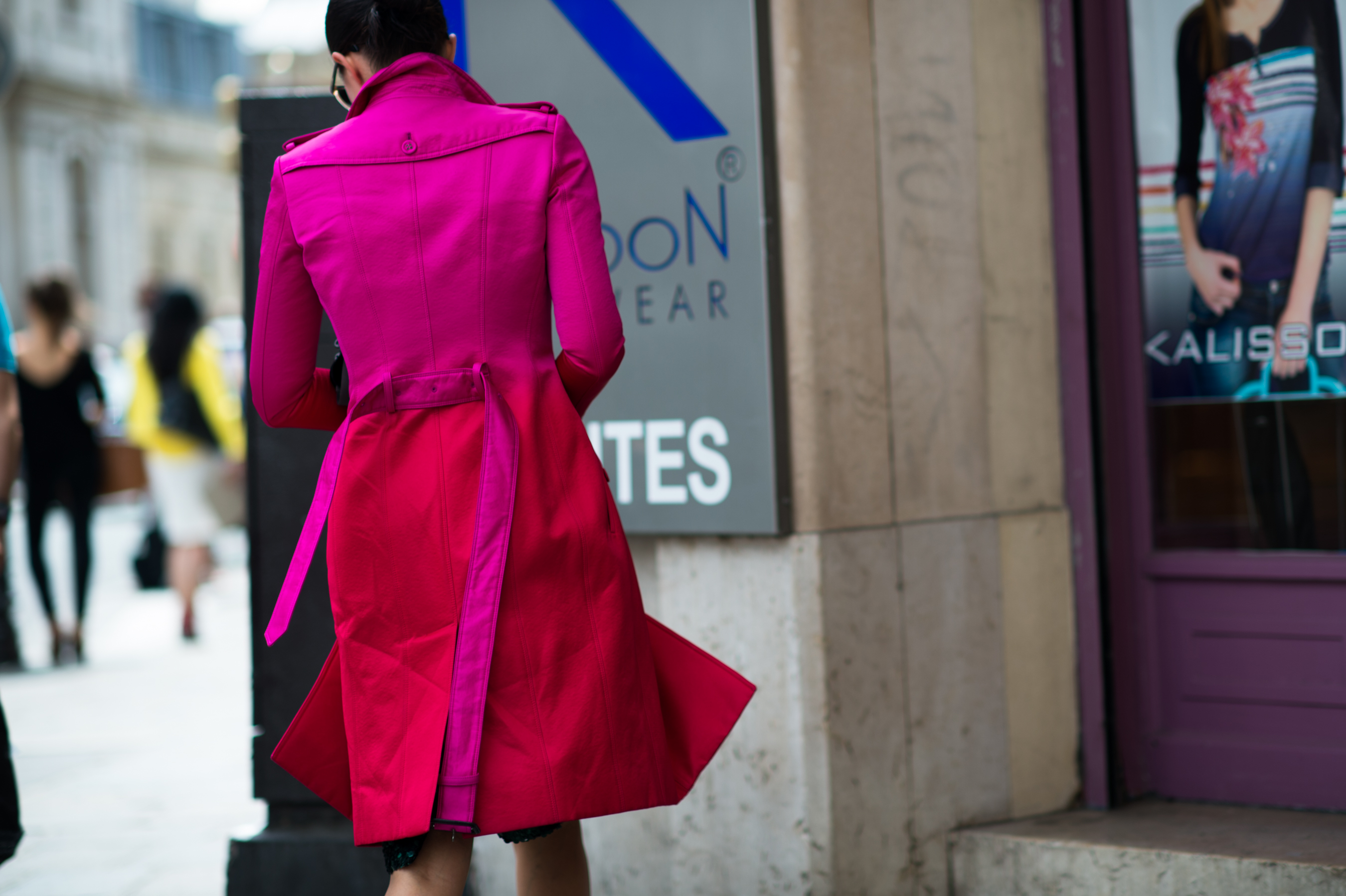 Woman wearing pink red ombré trench coat