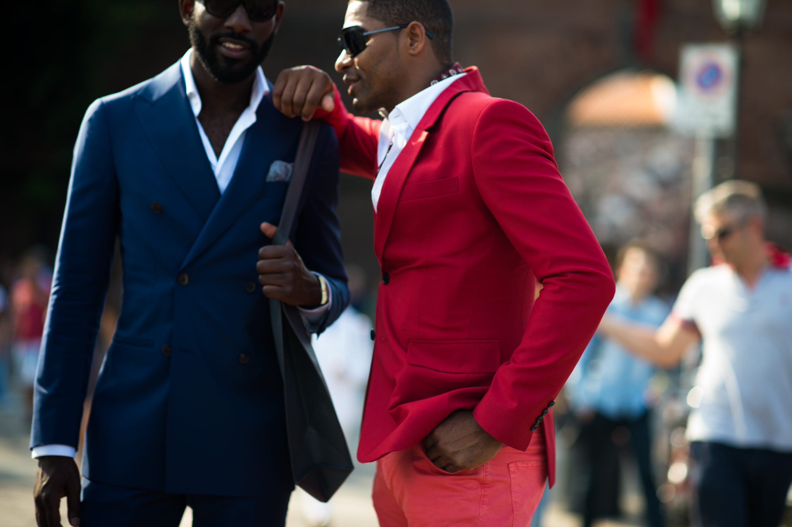 Two men wearing blue and red suits