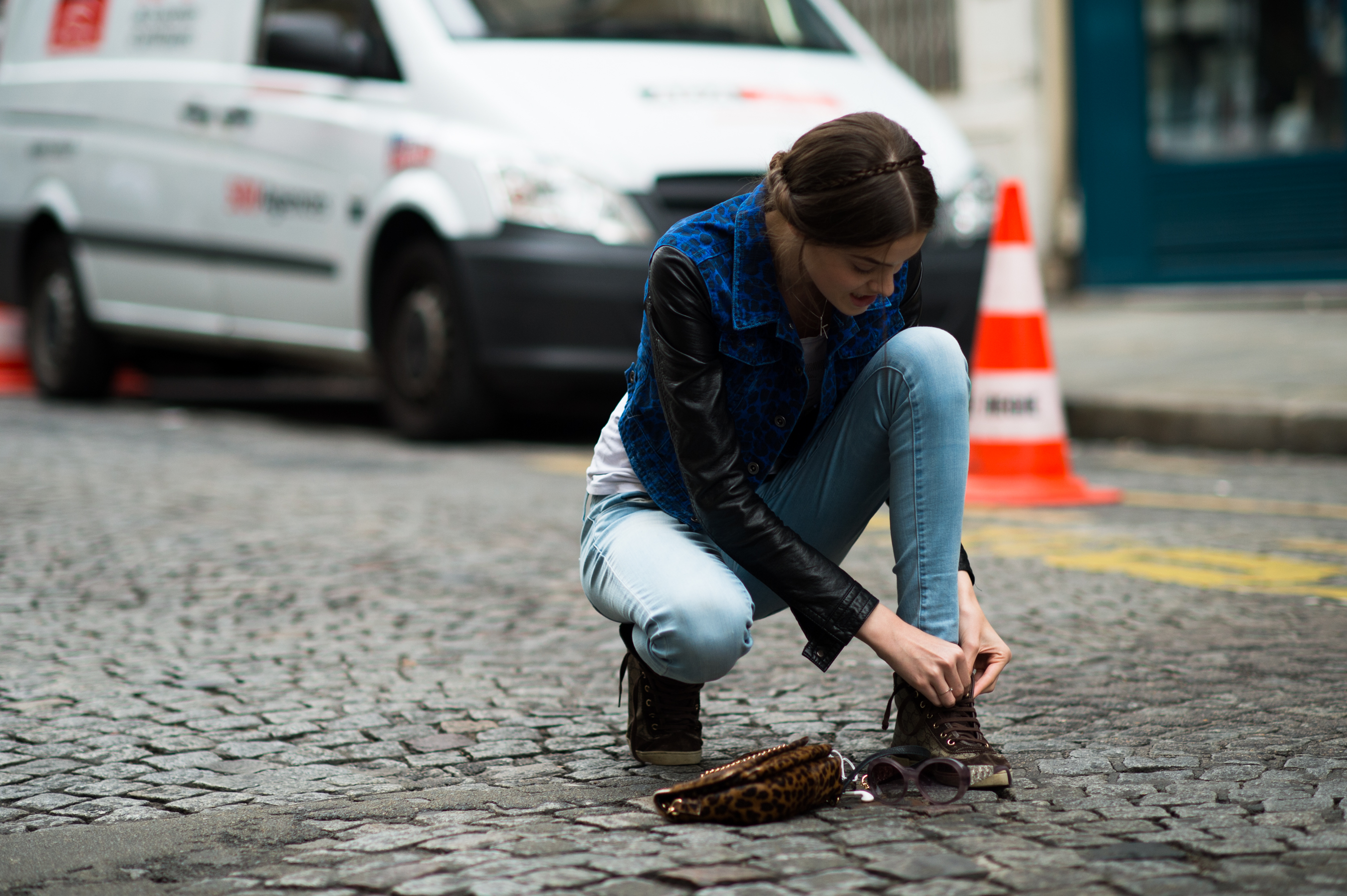 Model kneeling to tie her shoe