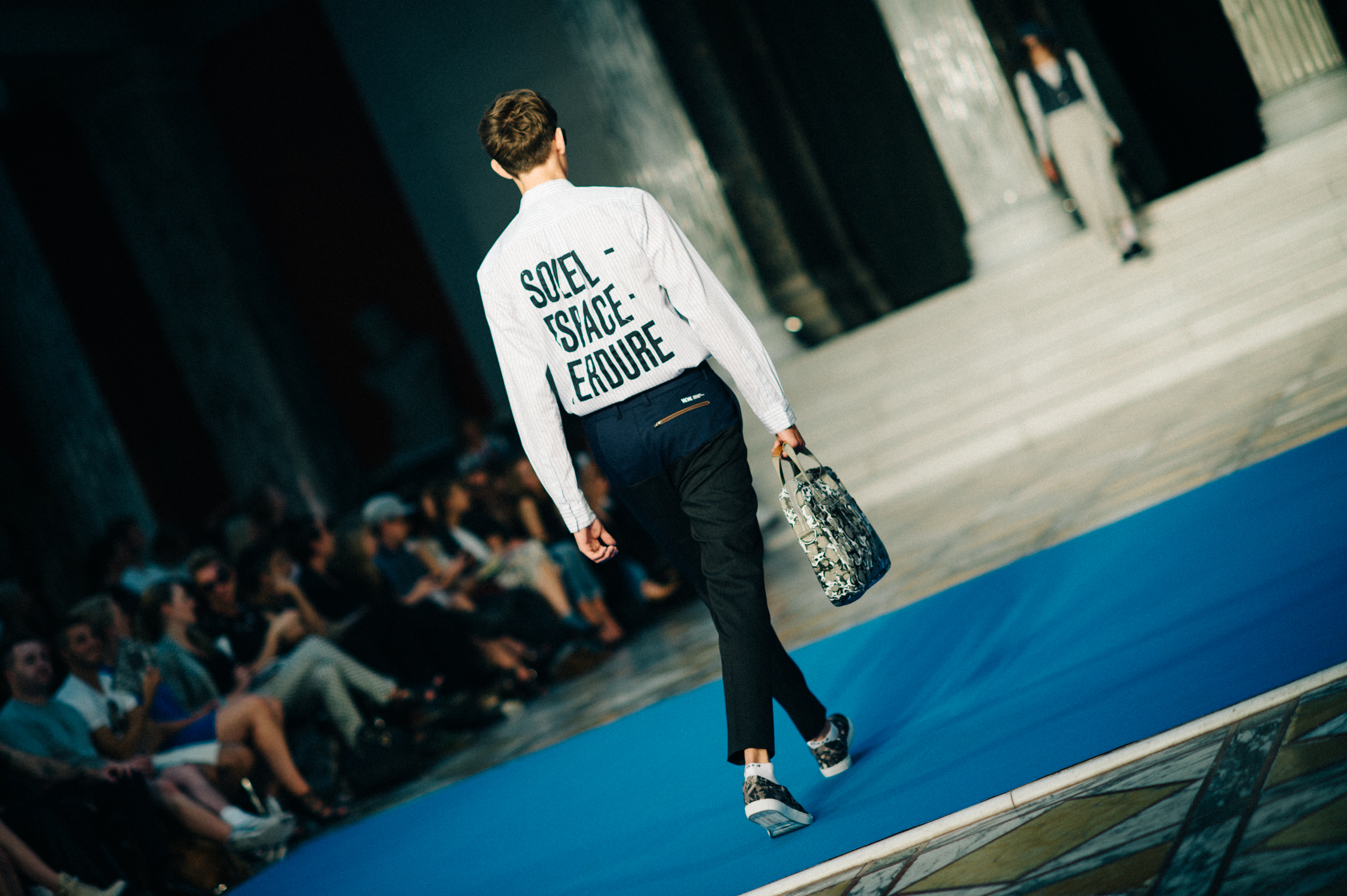 Male model walking fashion show runway
