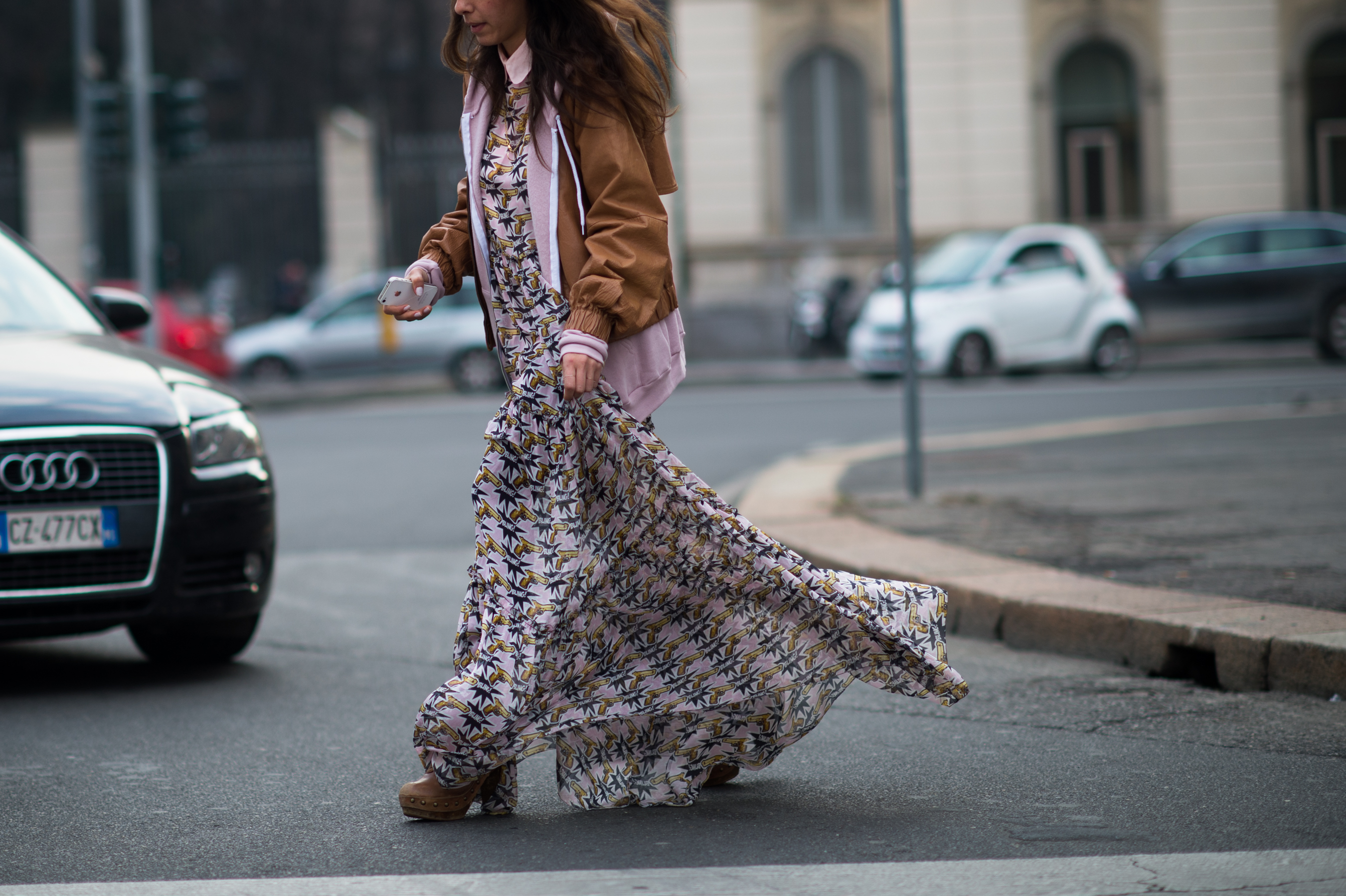 Girl in flowing dress crossing the street