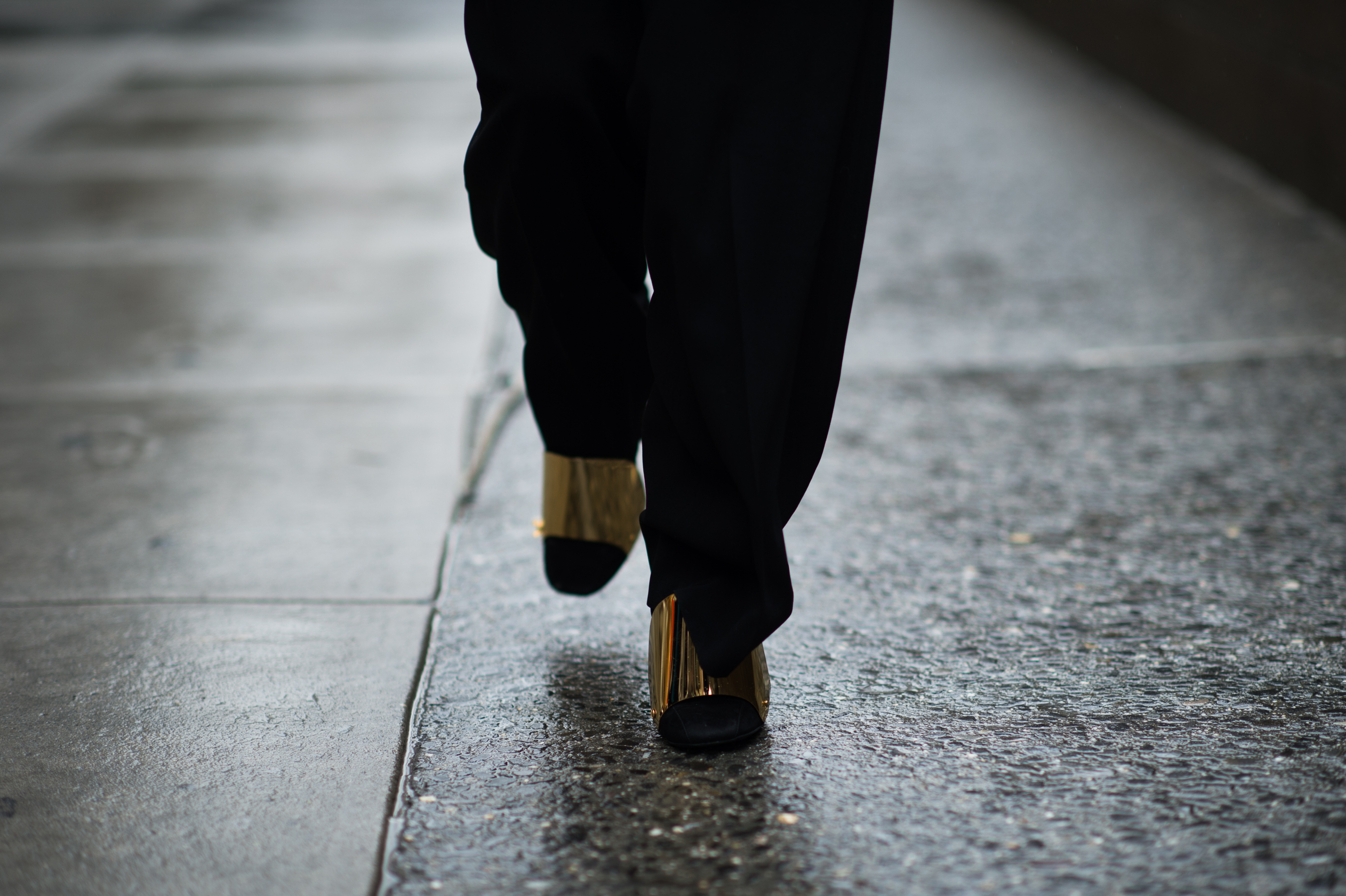 Woman wearing gold armour shoes
