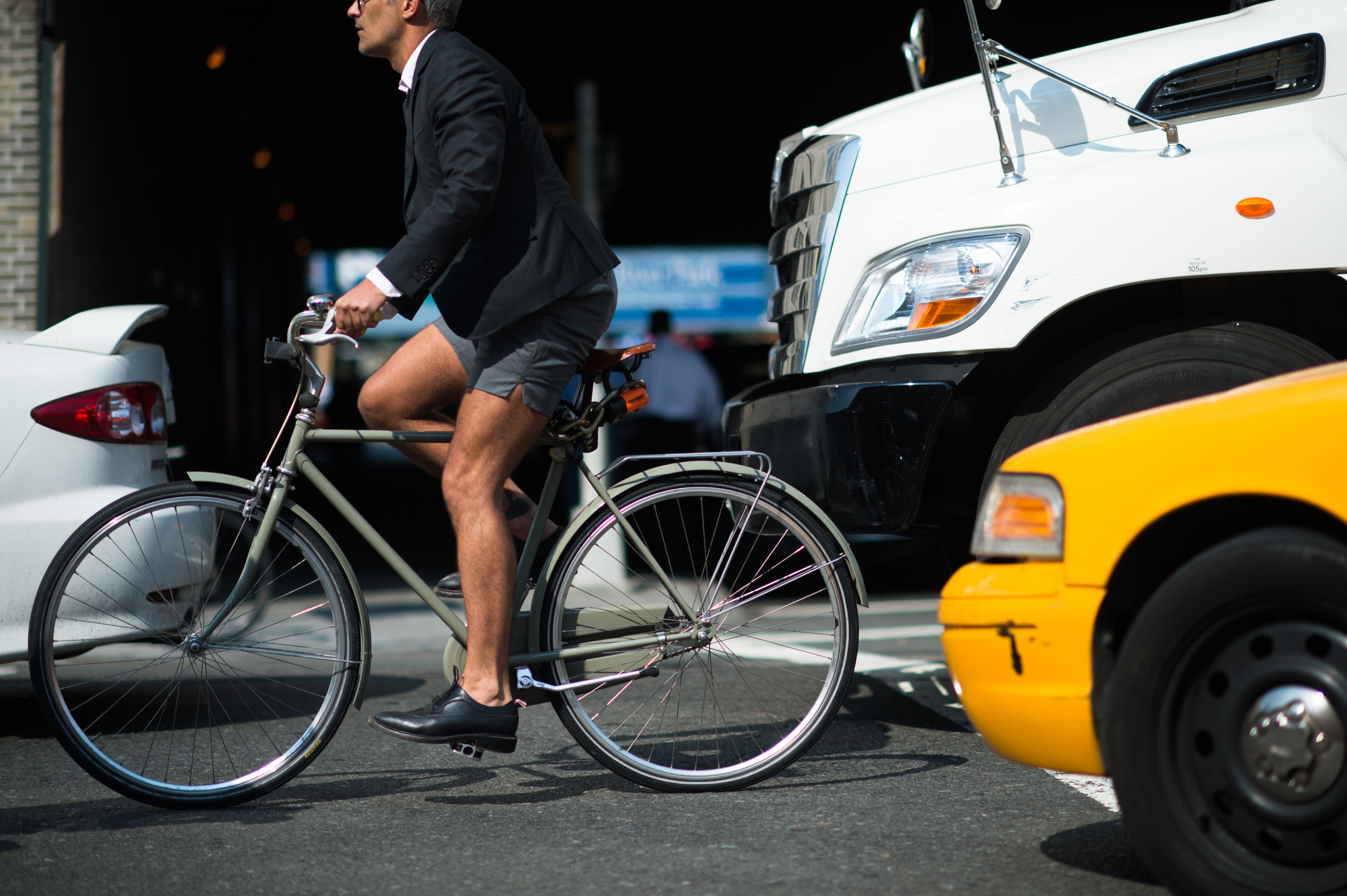 Man wearing Thom Browne on bicycle