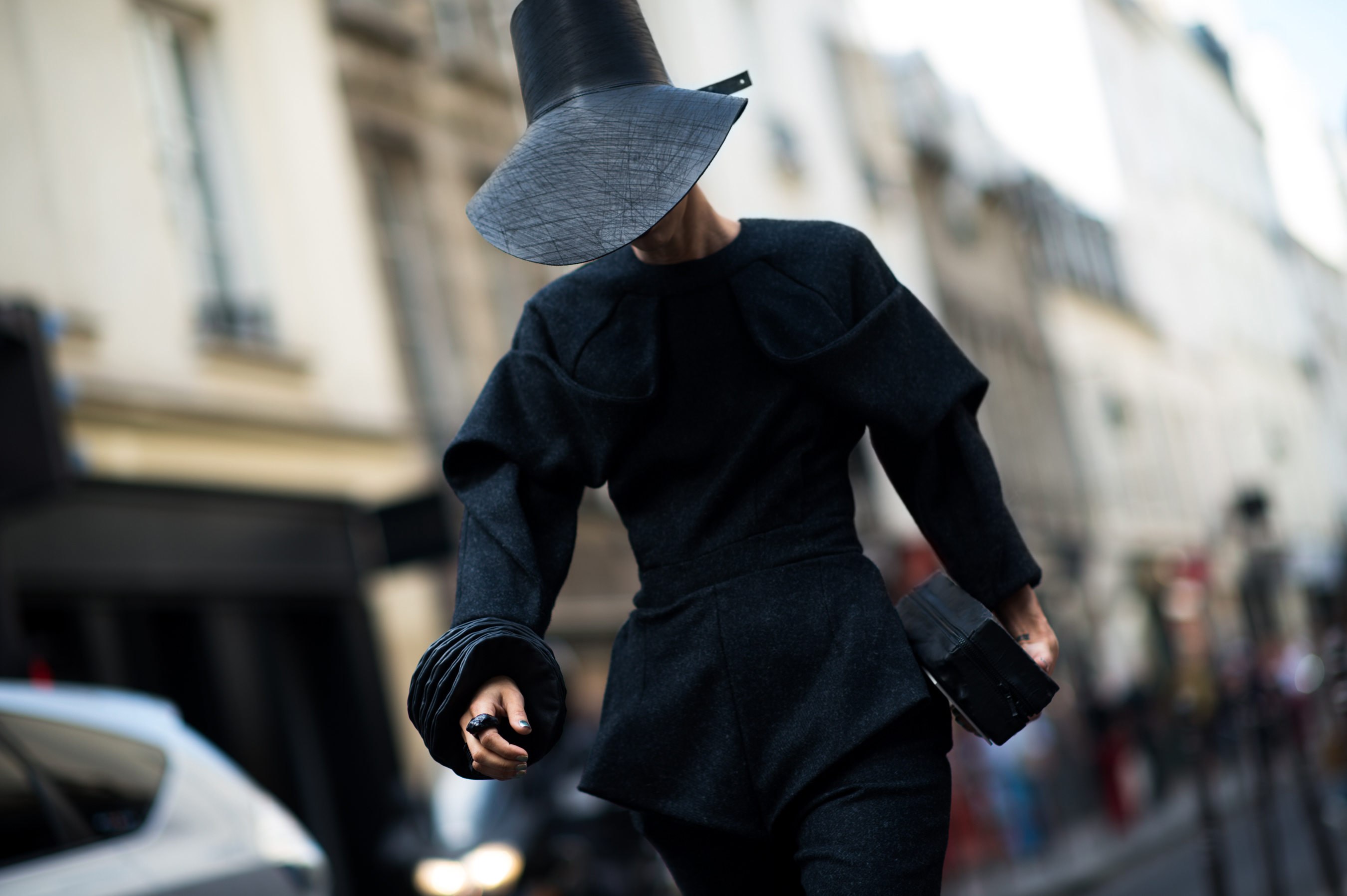 Woman wearing all black with hat