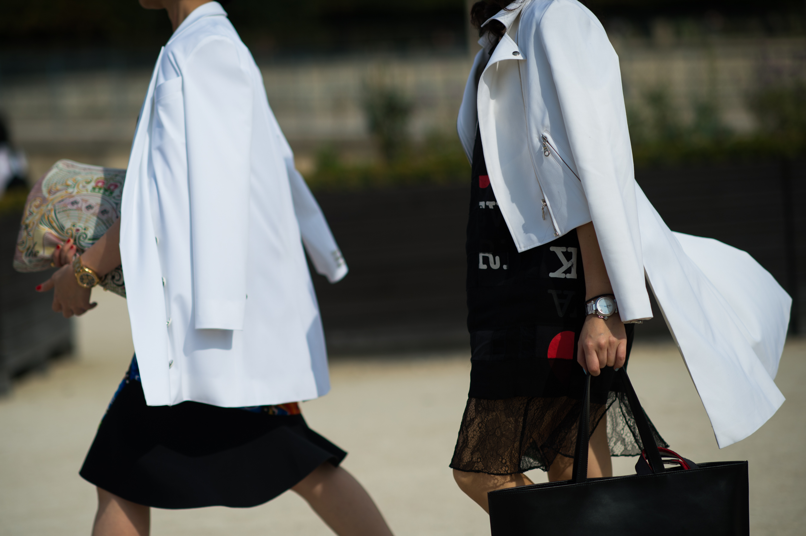 Two women wearing white jackets