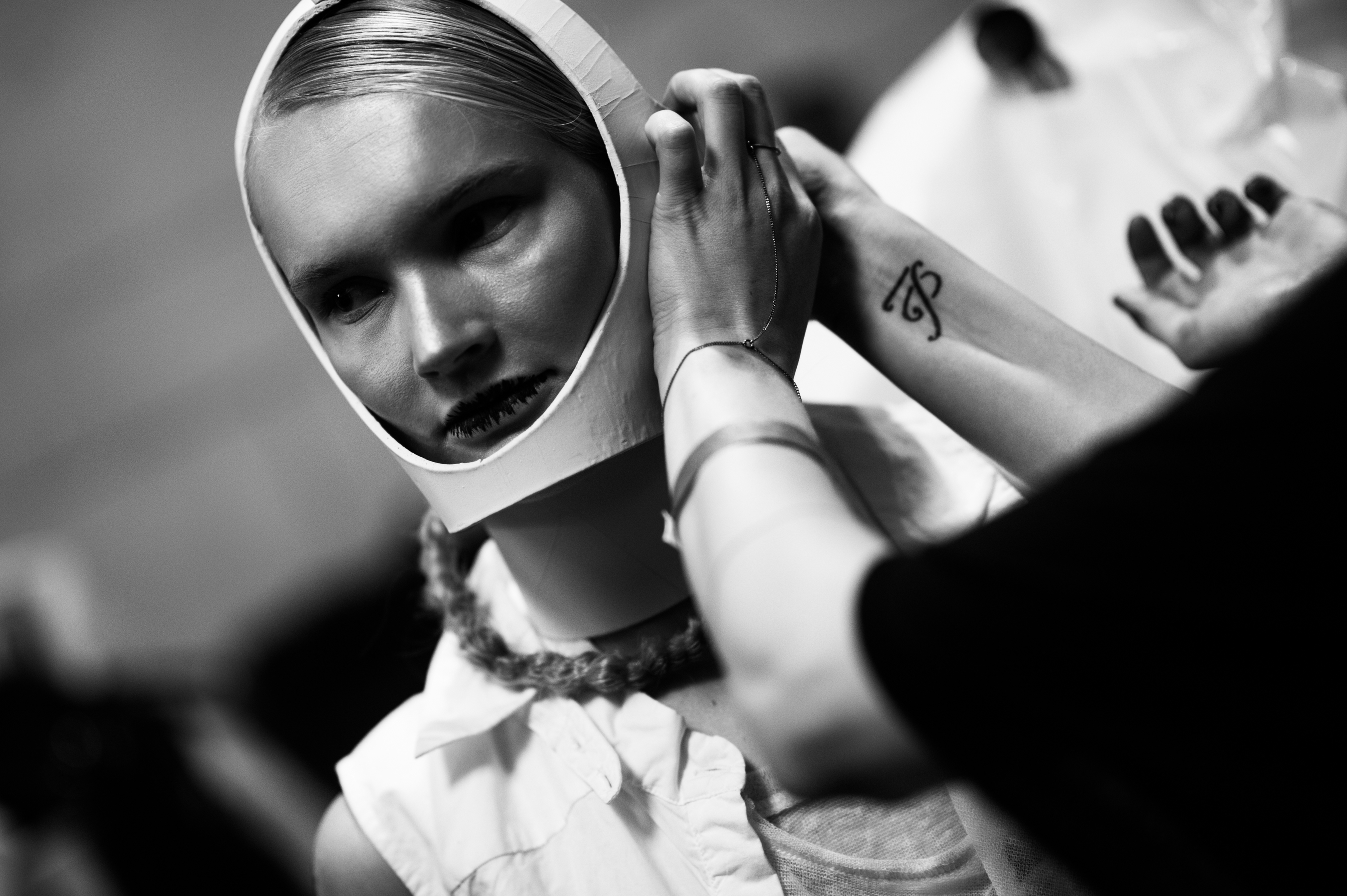 Model having white leather mask put on