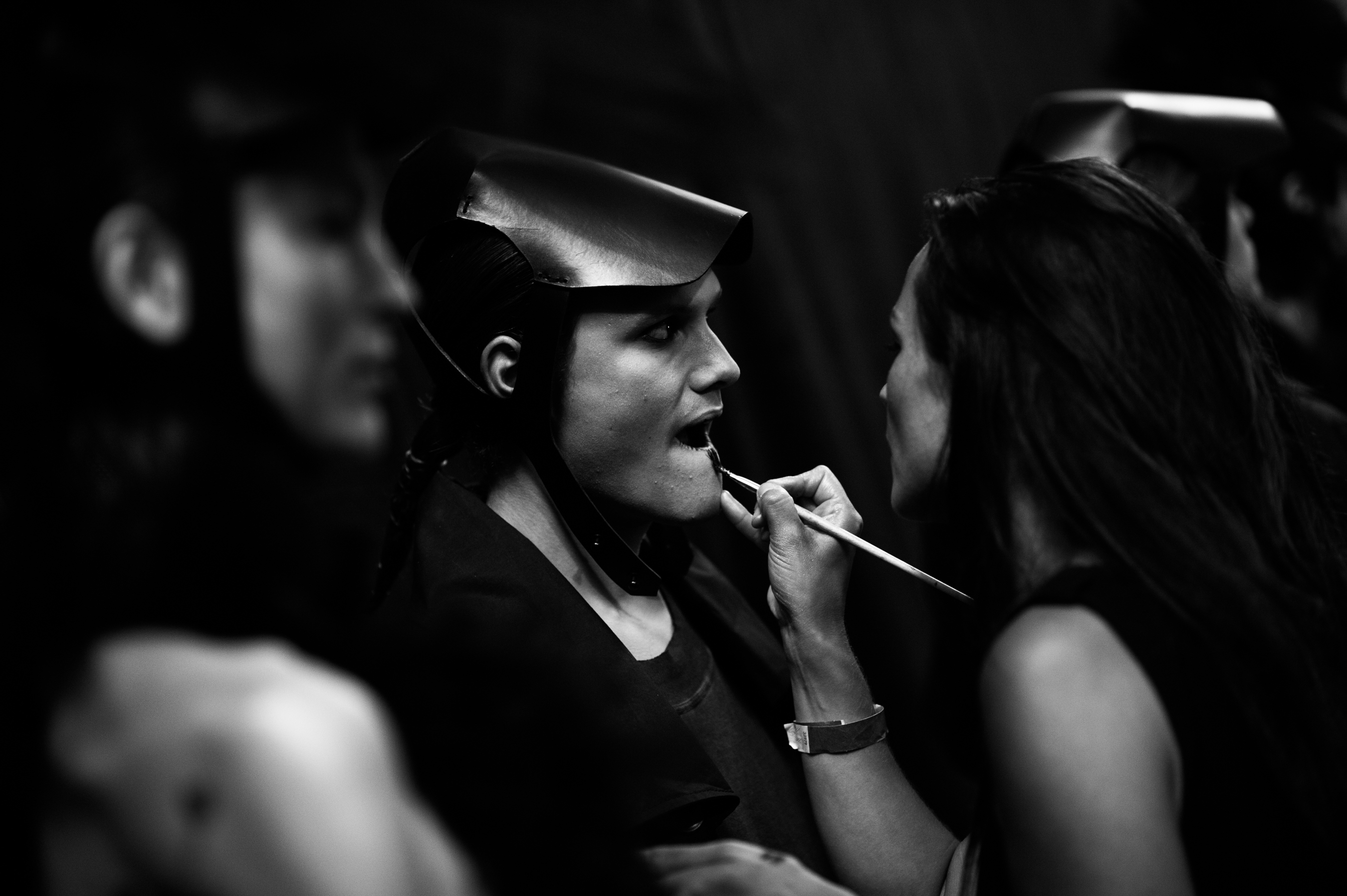 Male model having makeup done