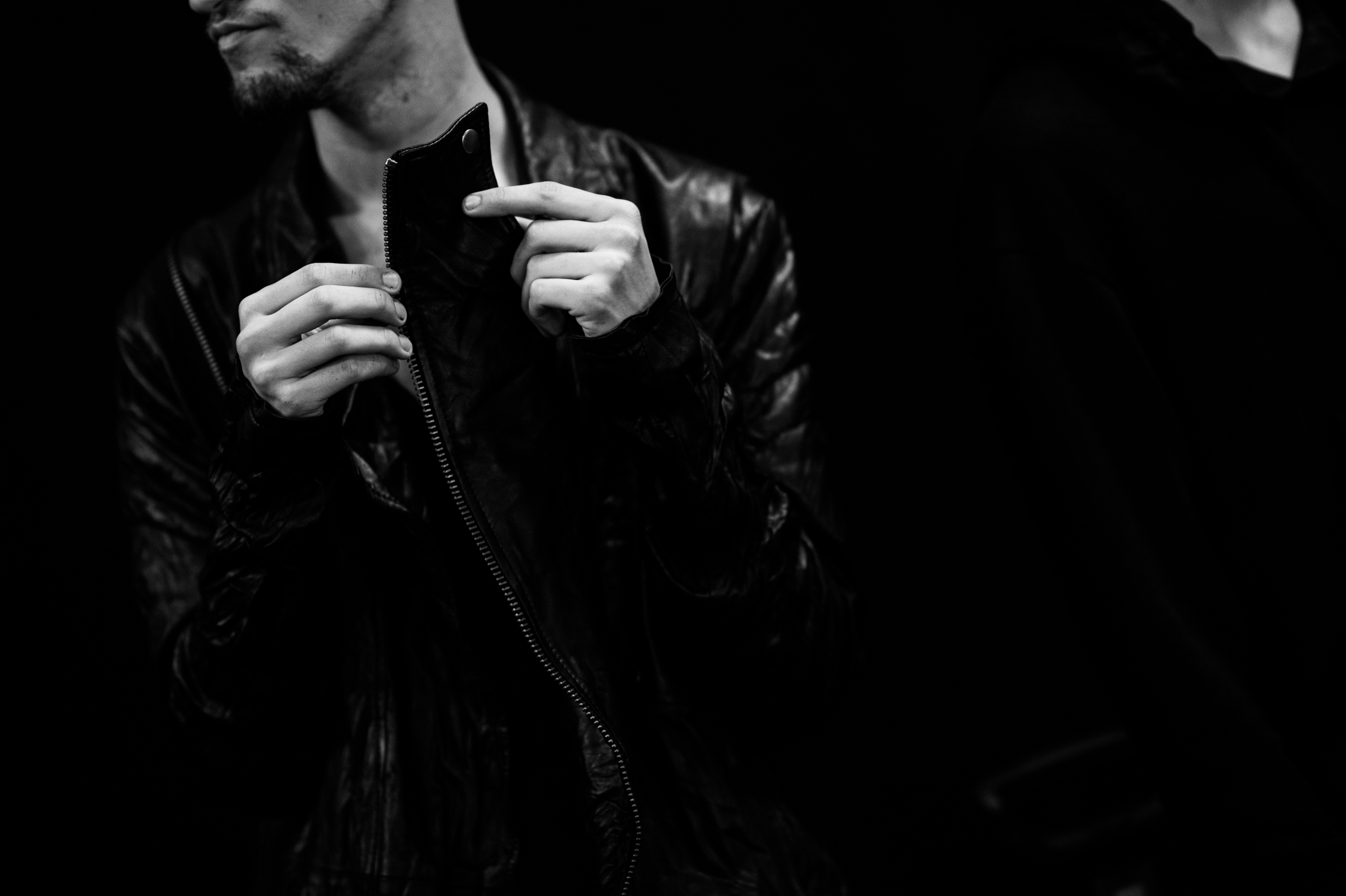 Male model playing with leather jacket