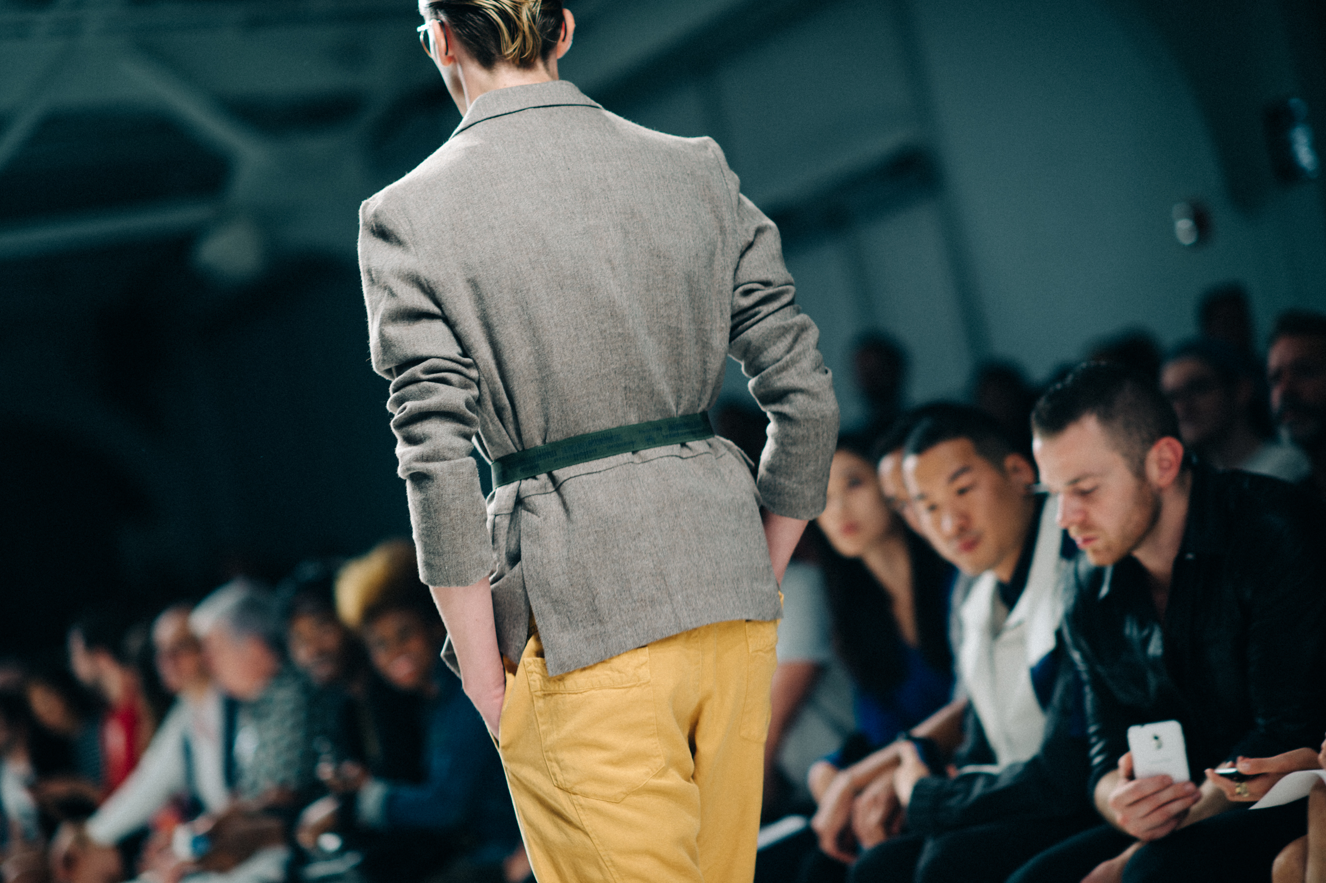 Male model wearing belted jacket