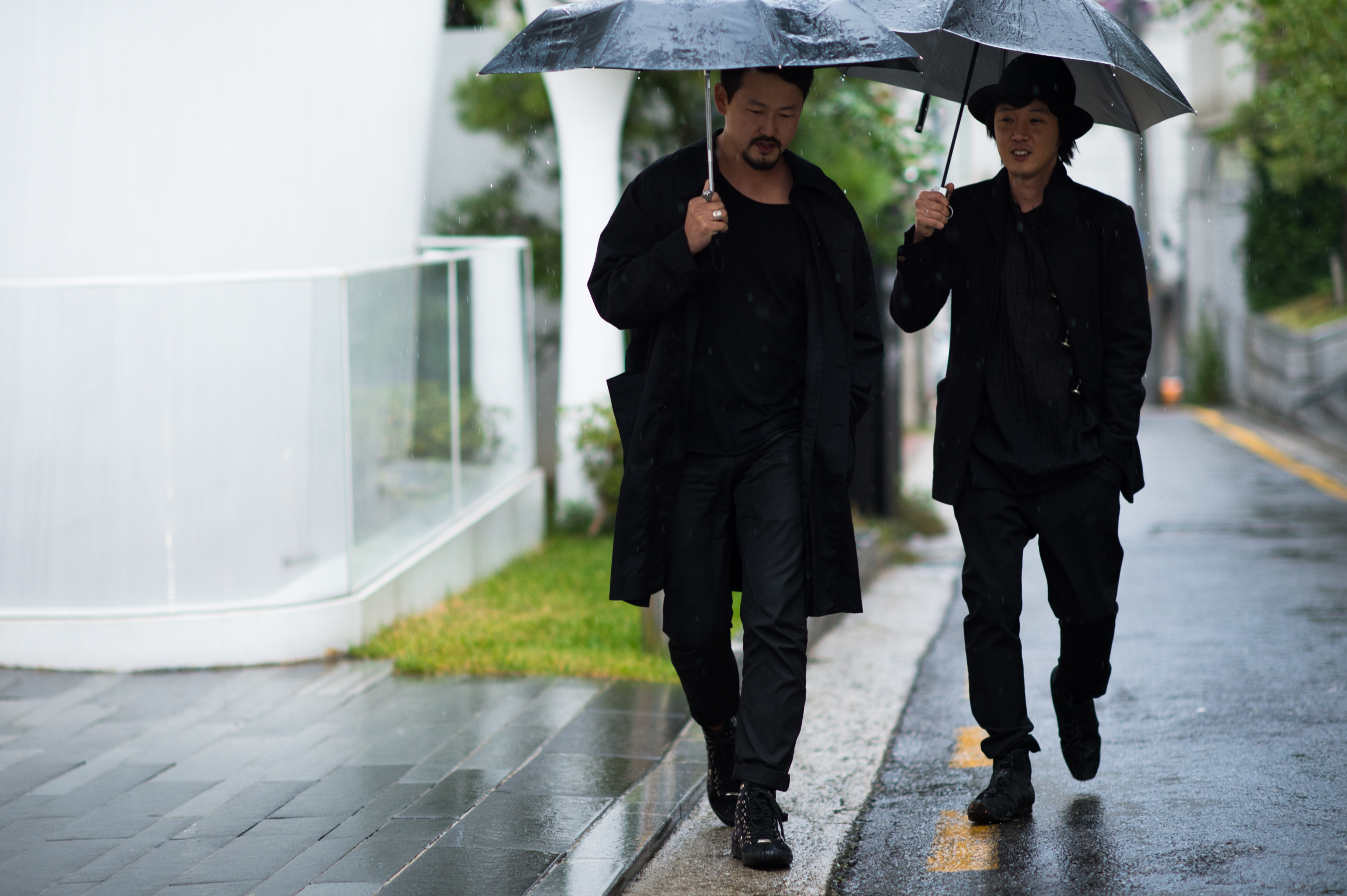 Two Korean men wearing all black