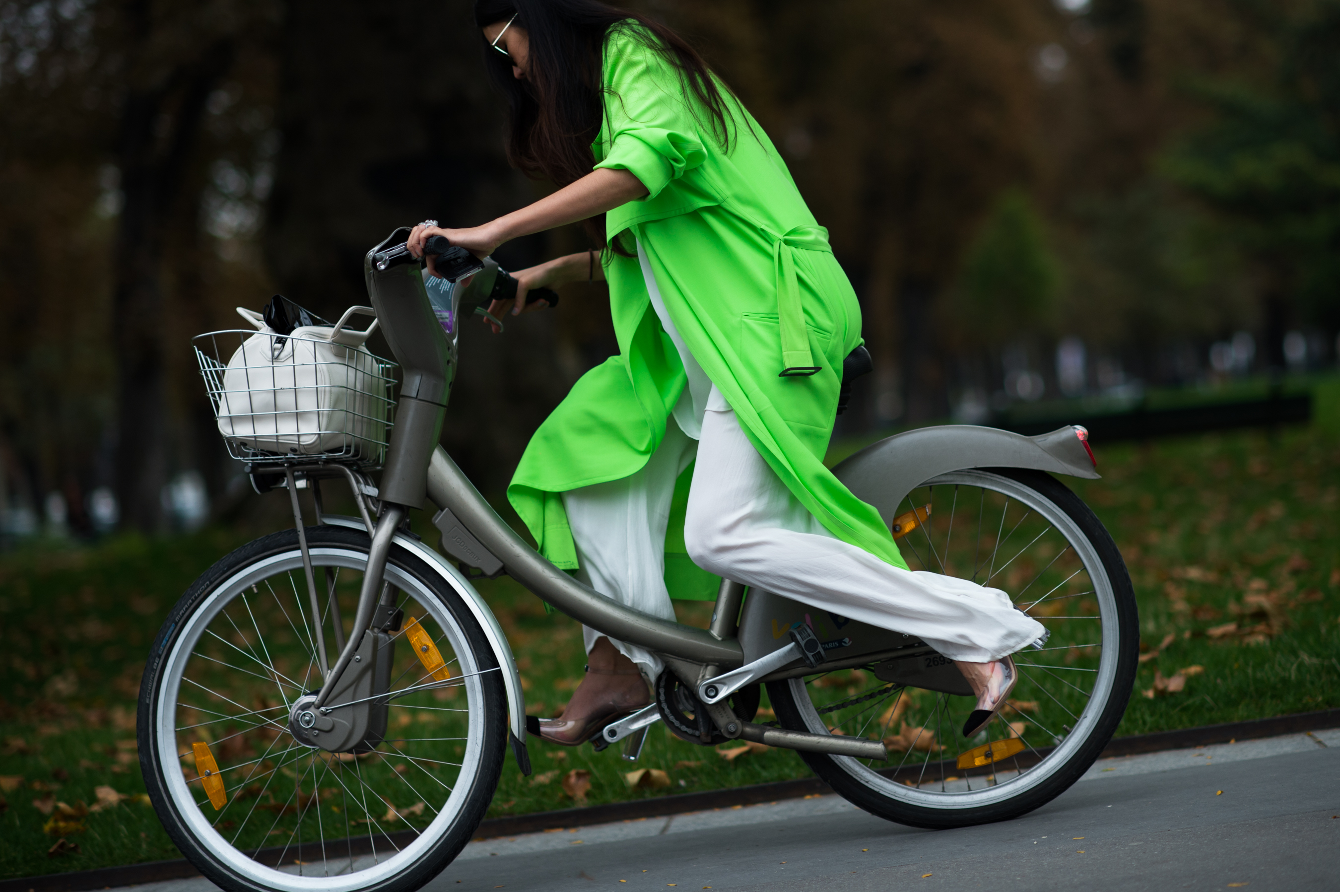 Woman in neon green jacket on bicycle