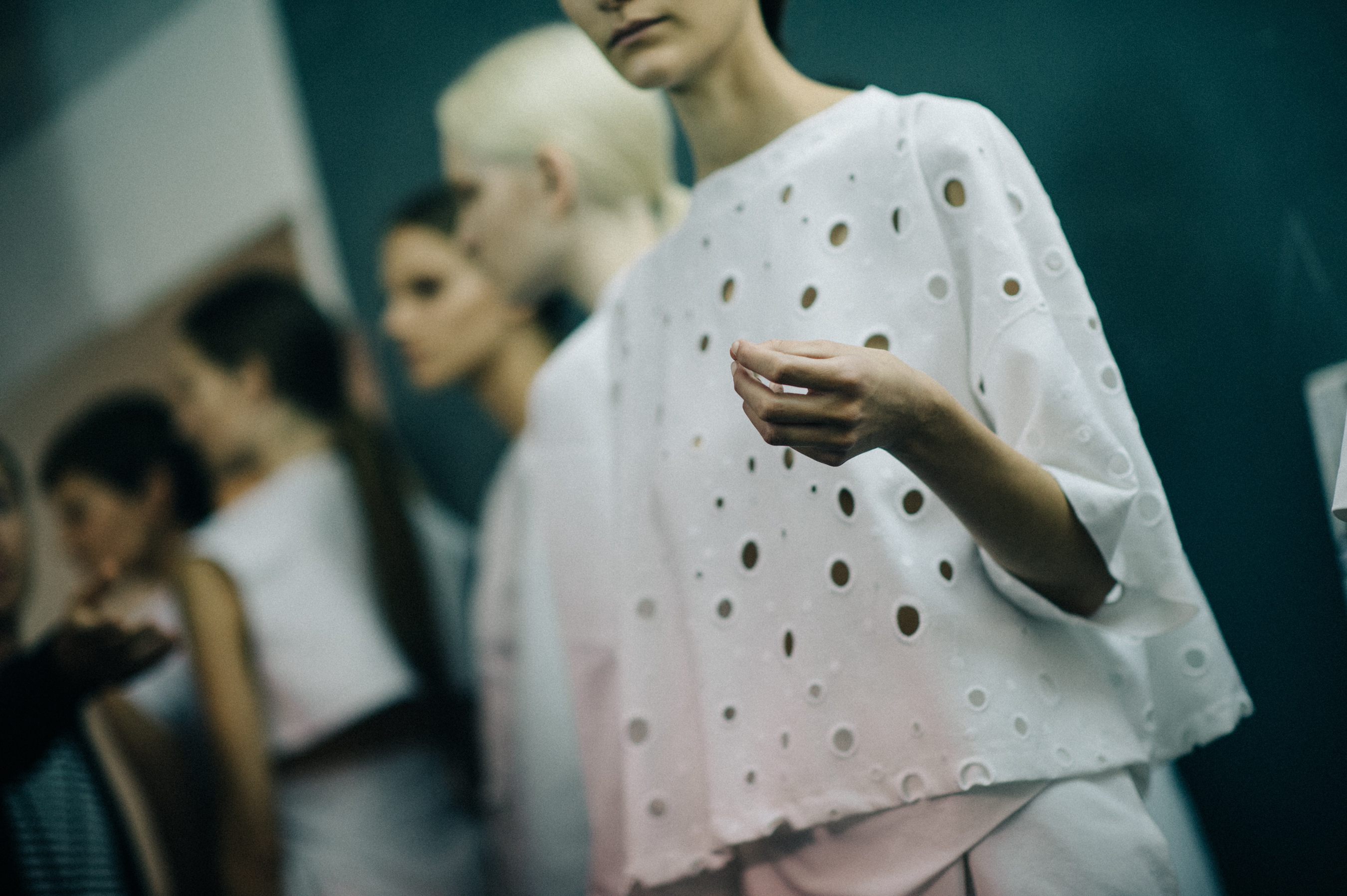 Model wearing white perforated top
