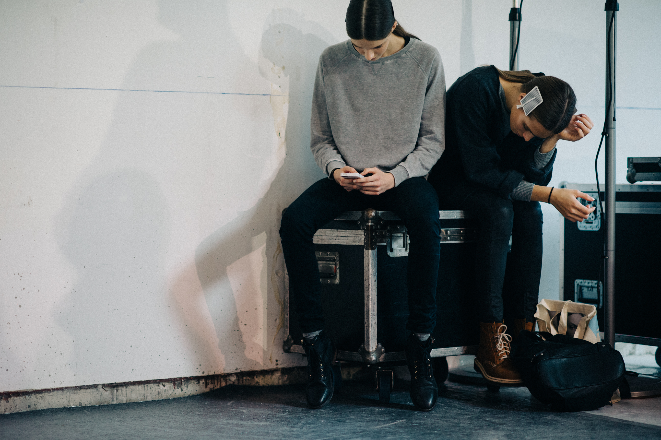 Two models sitting on container