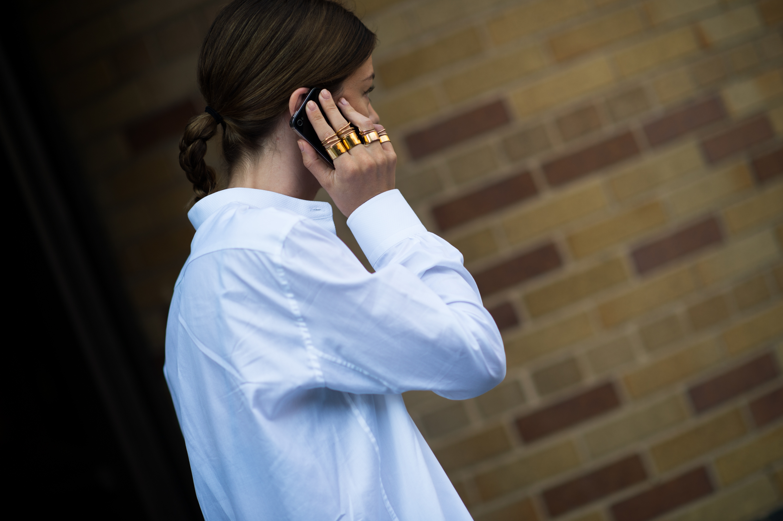 Woman wearing set of gold rings