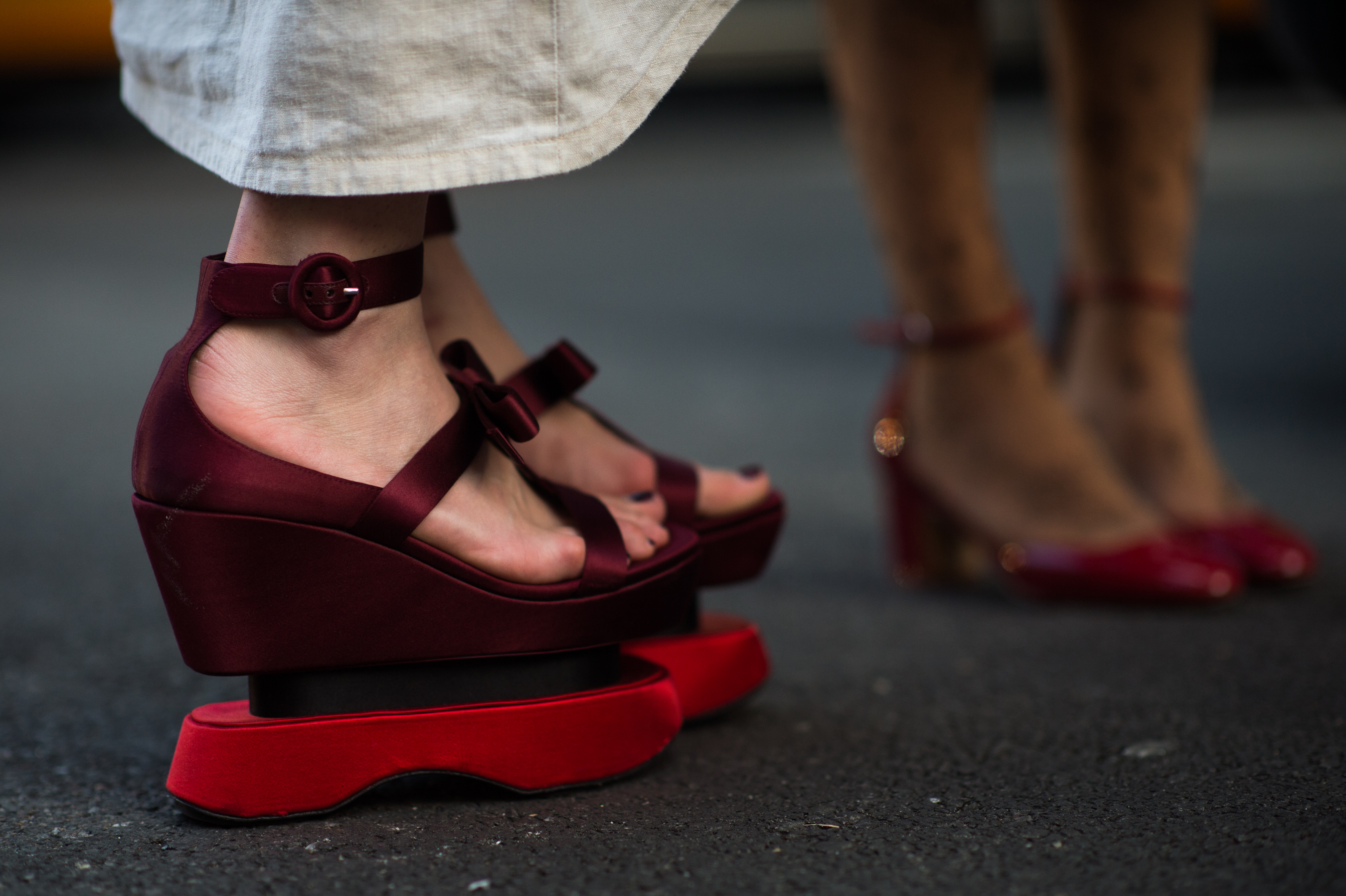 Woman wearing red satin shoes